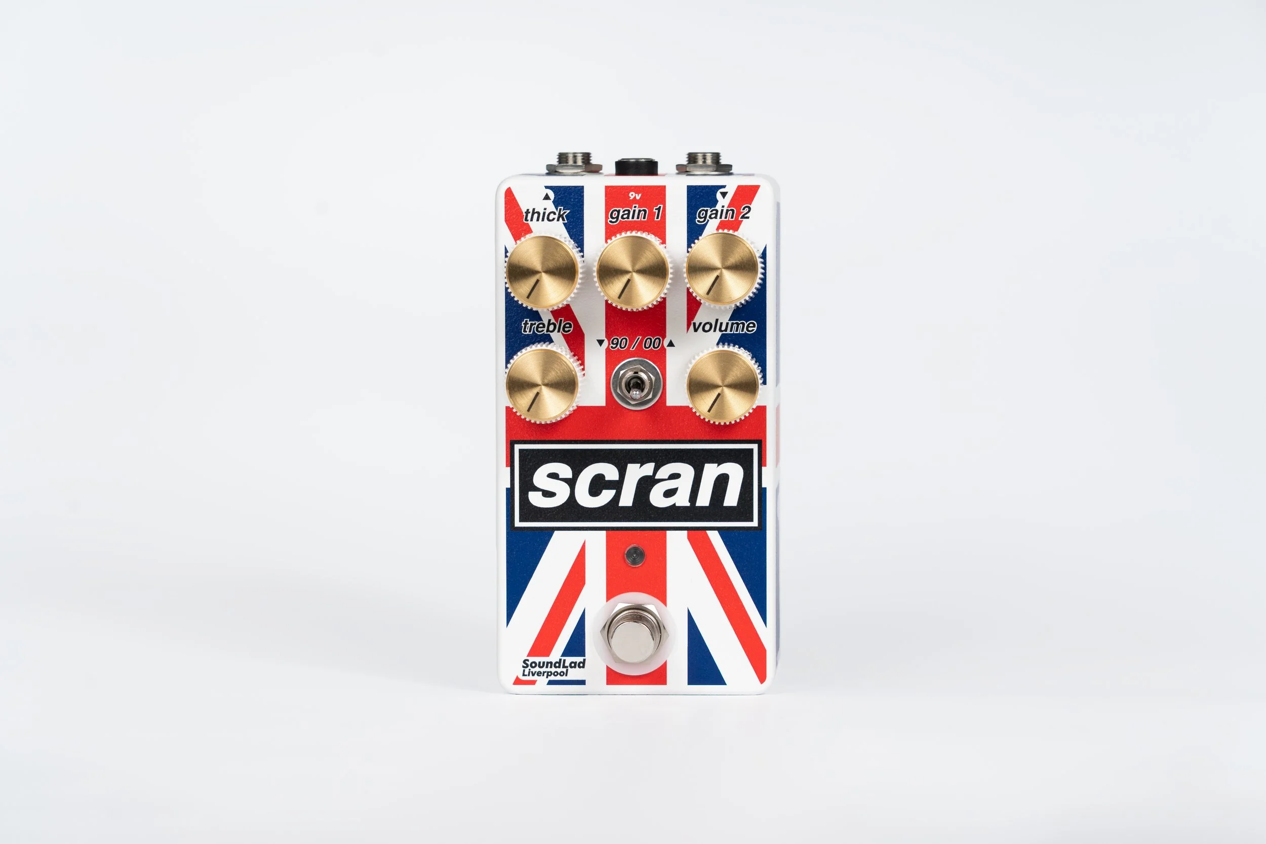 Guitar effects pedal with a Union Jack design, labeled 'scran,' with five gold control knobs and a footswitch at the bottom.