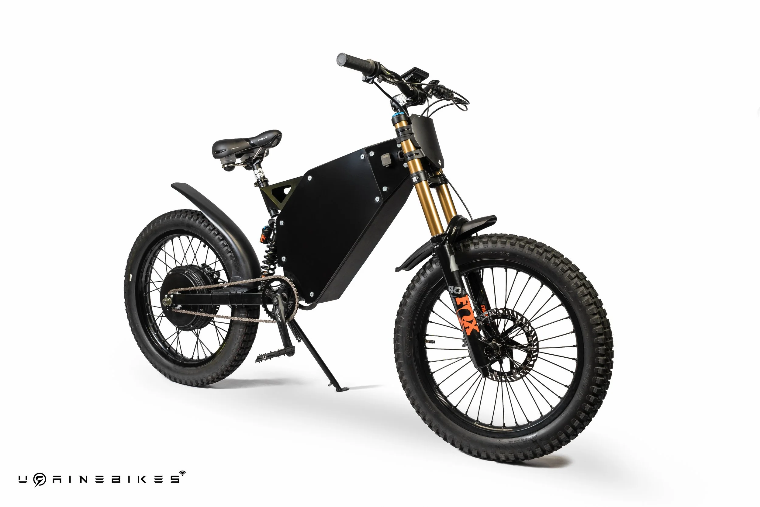 Electric fat tire mountain bike with black frame, gold front suspension fork, wide knobby tires, and branding on the fork.