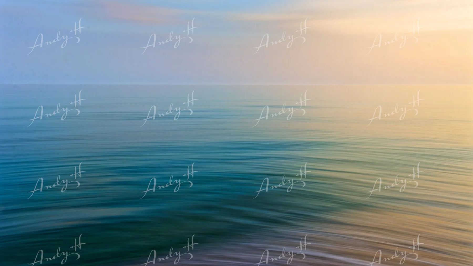 An abstract fine art print, of calm ocean water with gentle ripples reflecting the coluors of the sky during sunset, with a gradient of blue, pink, and orange hues across the sky.