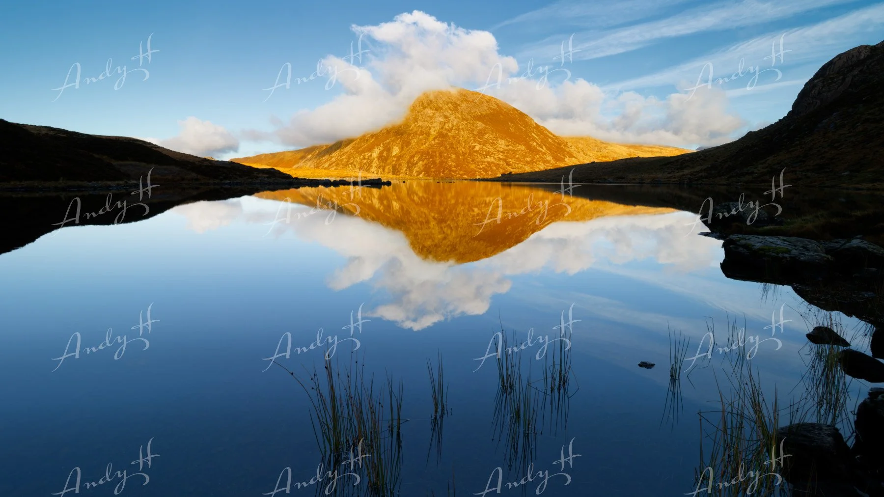 Landscape Photography fine art print, A mountain reflected in a calm lake with clear blue sky and some clouds. Pen yr Ole Wen and Llyn Idwal, Snowdonia