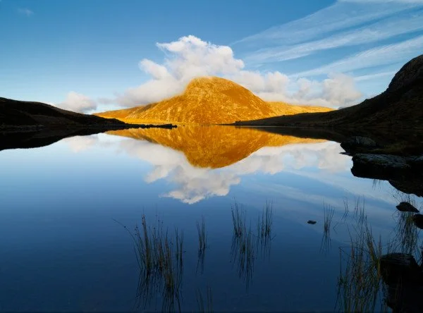 Landscape Photography fine art print, A mountain reflected in a calm lake with clear blue sky and some clouds. Pen yr Ole Wen and Llyn Idwal, Snowdonia