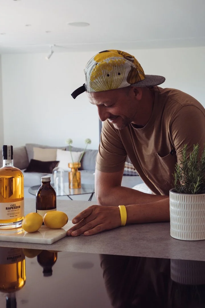Sebastian in a colourful cap at a kitchen counter with lemons