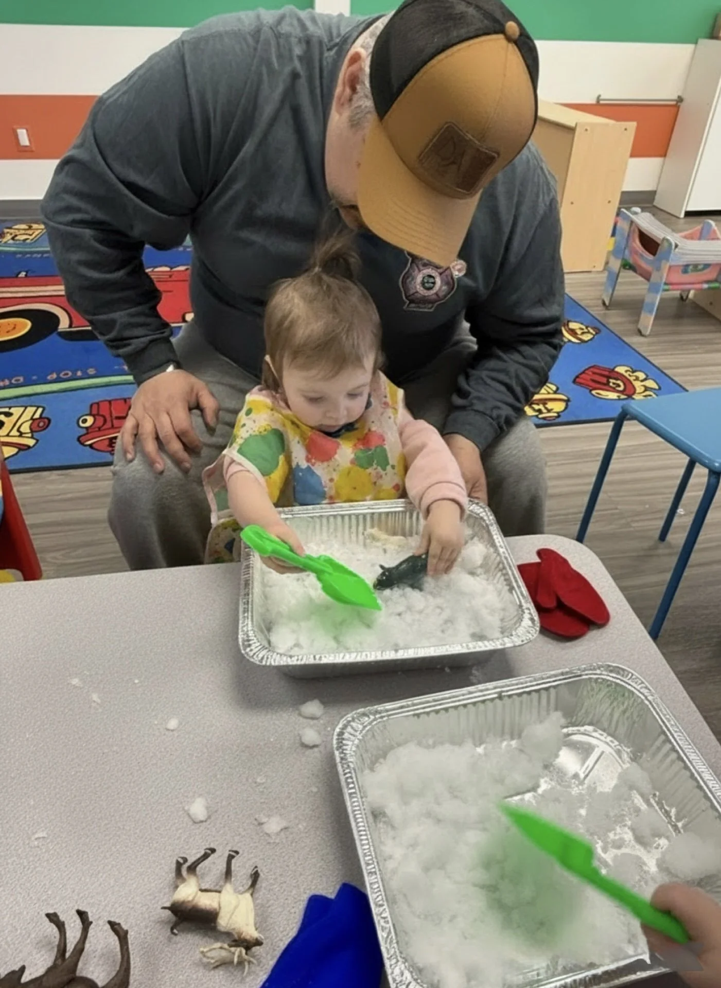 Dad and toddler exploring a winter sensory activity together during a Kid Ka Doodle Mini Doodlers class in Hunterdon County, NJ.