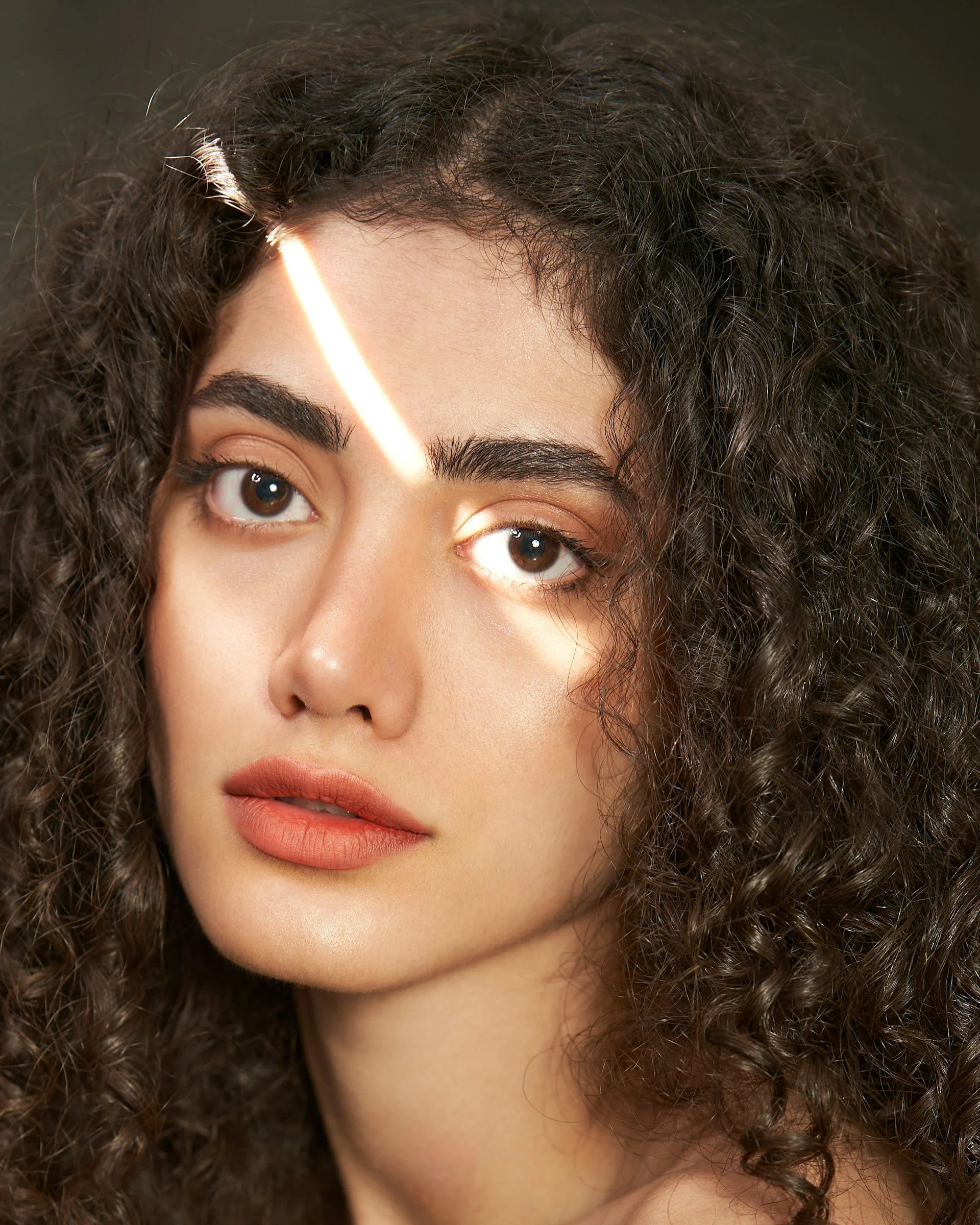 Close-up of natural brows and skin, highlighting full eyebrow shape and clean, well-groomed beauty results