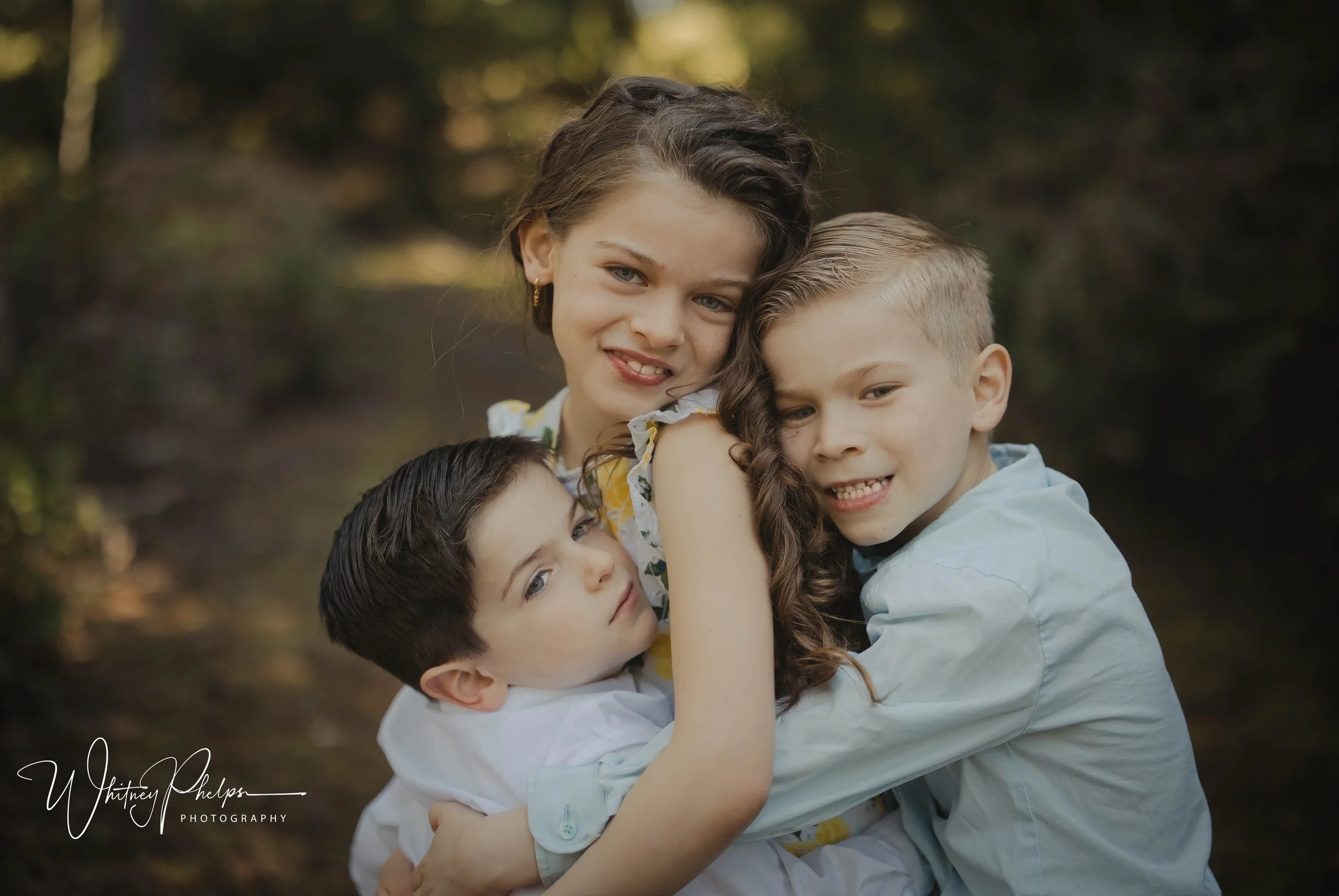 Siblings sharing a candid moment during a family photo session  McCormick Woods Port Orchard WA