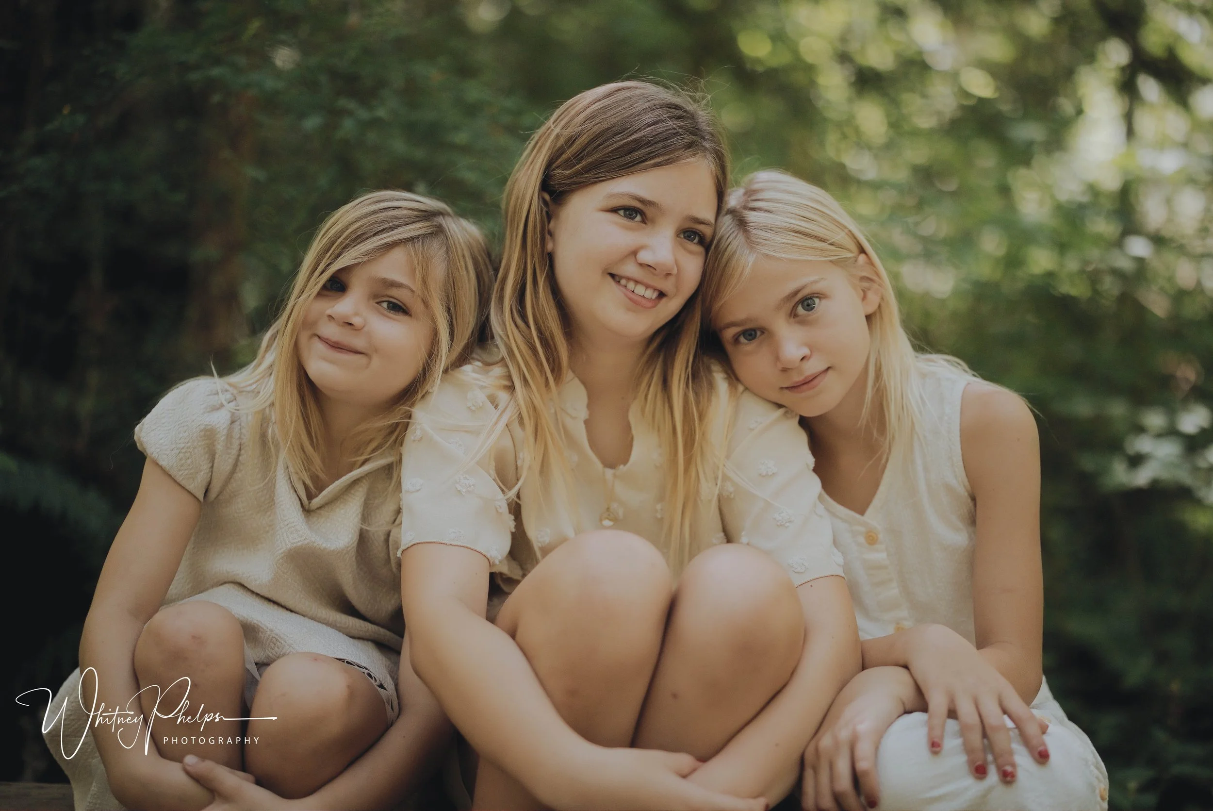 Capturing the bond between three sisters surrounded by the beauty of the Pacific Northwest. A playful outdoor family photography session at Sehmel Homestead Park.