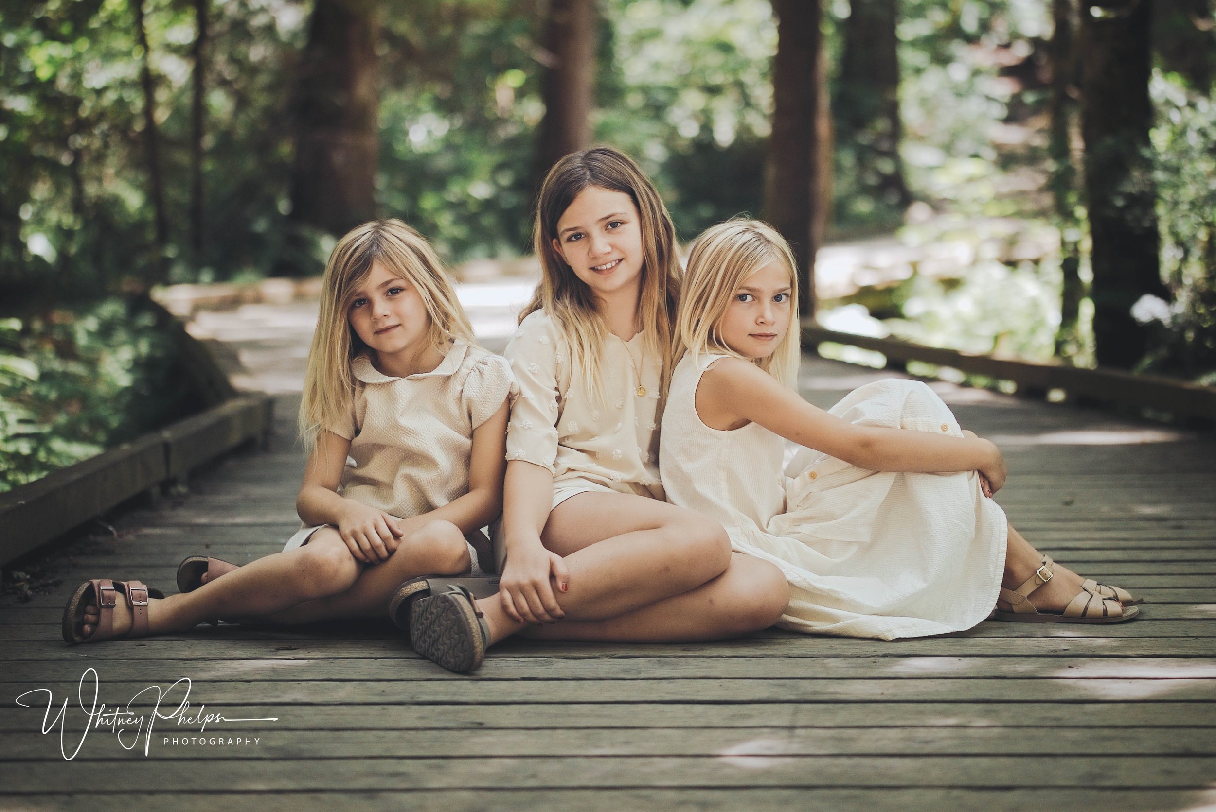 Three sisters exploring the forest trails and boardwalk at Sehmel Homestead Park in Gig Harbor, Washington.