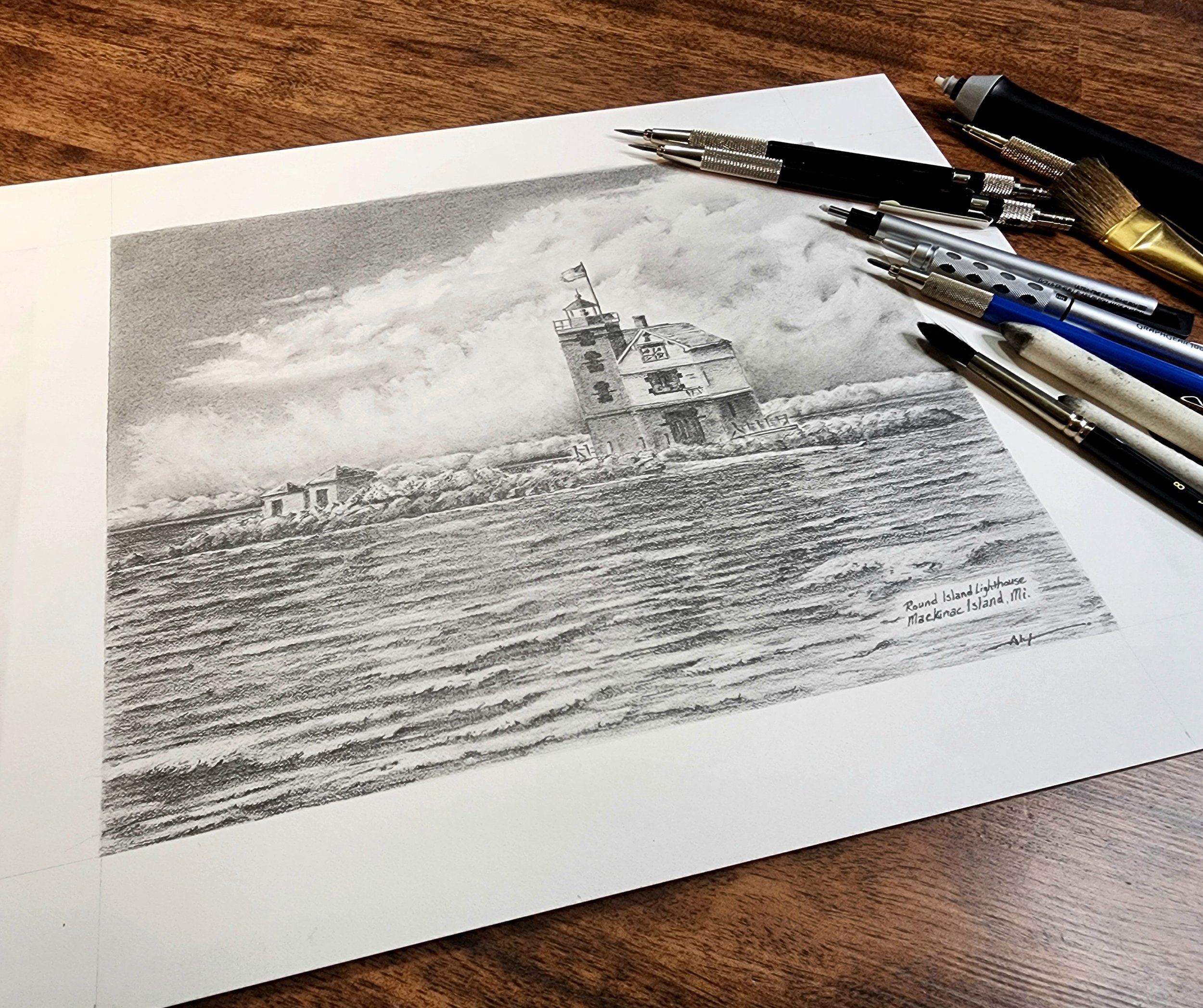 A black and white drawing of Round Island Lighthouse on a beach with buildings around it