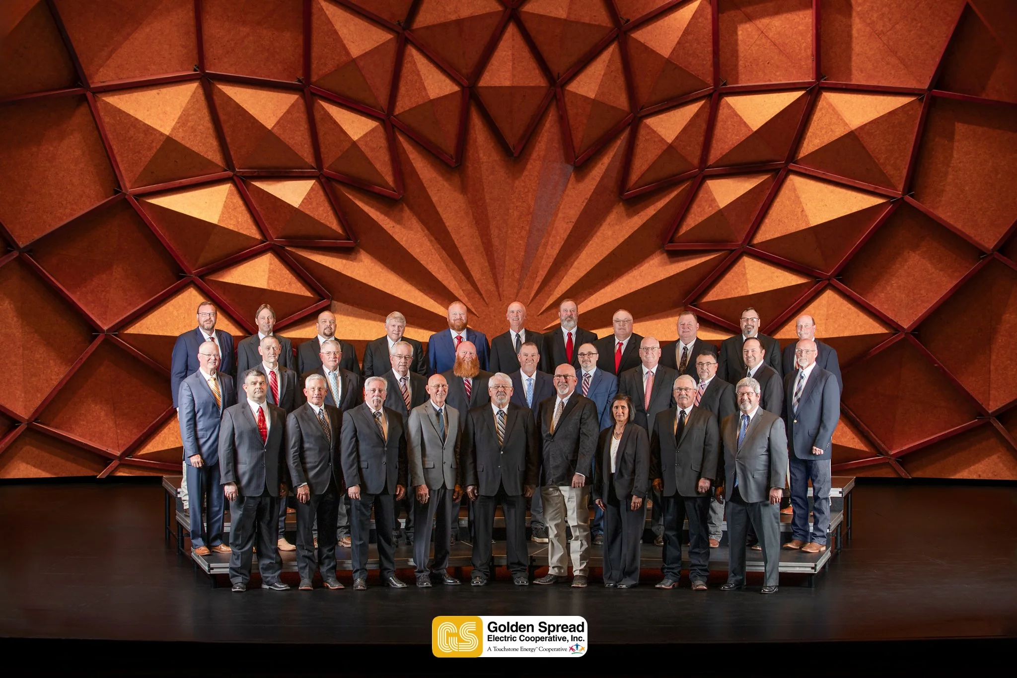 Professional group photo captured during an annual shareholder meeting, photographed on-site with clean, consistent lighting.