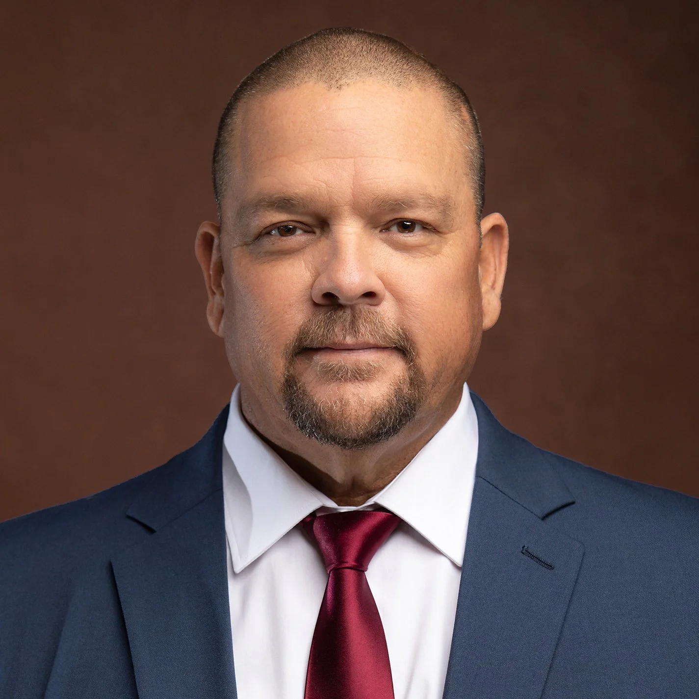 Business litigation attorney headshot with modern studio lighting