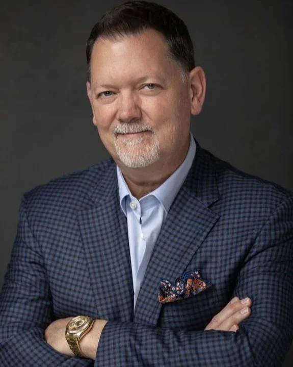 Professional headshot of friendly male professional in Amarillo Texas wearing blue jacket and open collar