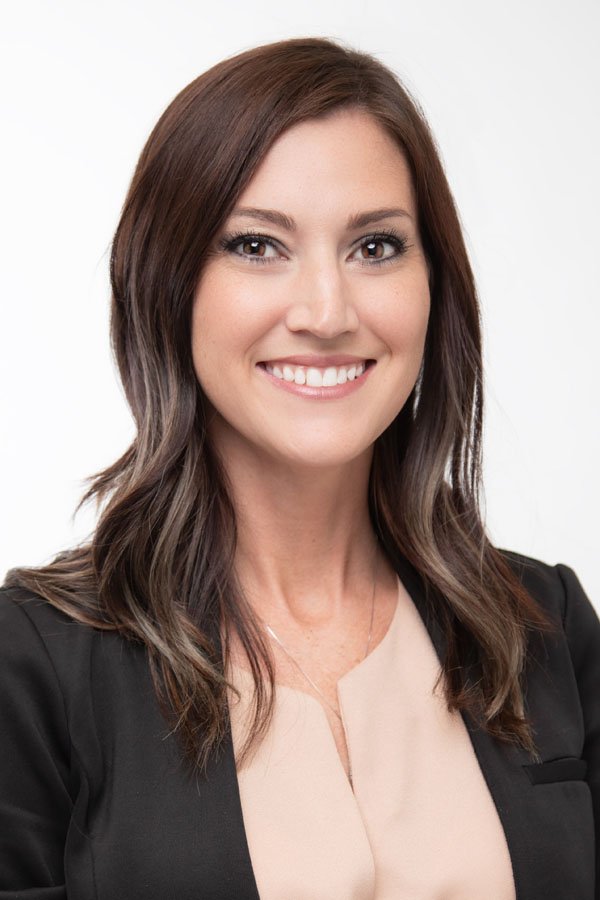 Approachable professional headshot of smiling businesswoman in Amarillo Texas with natural studio lighting