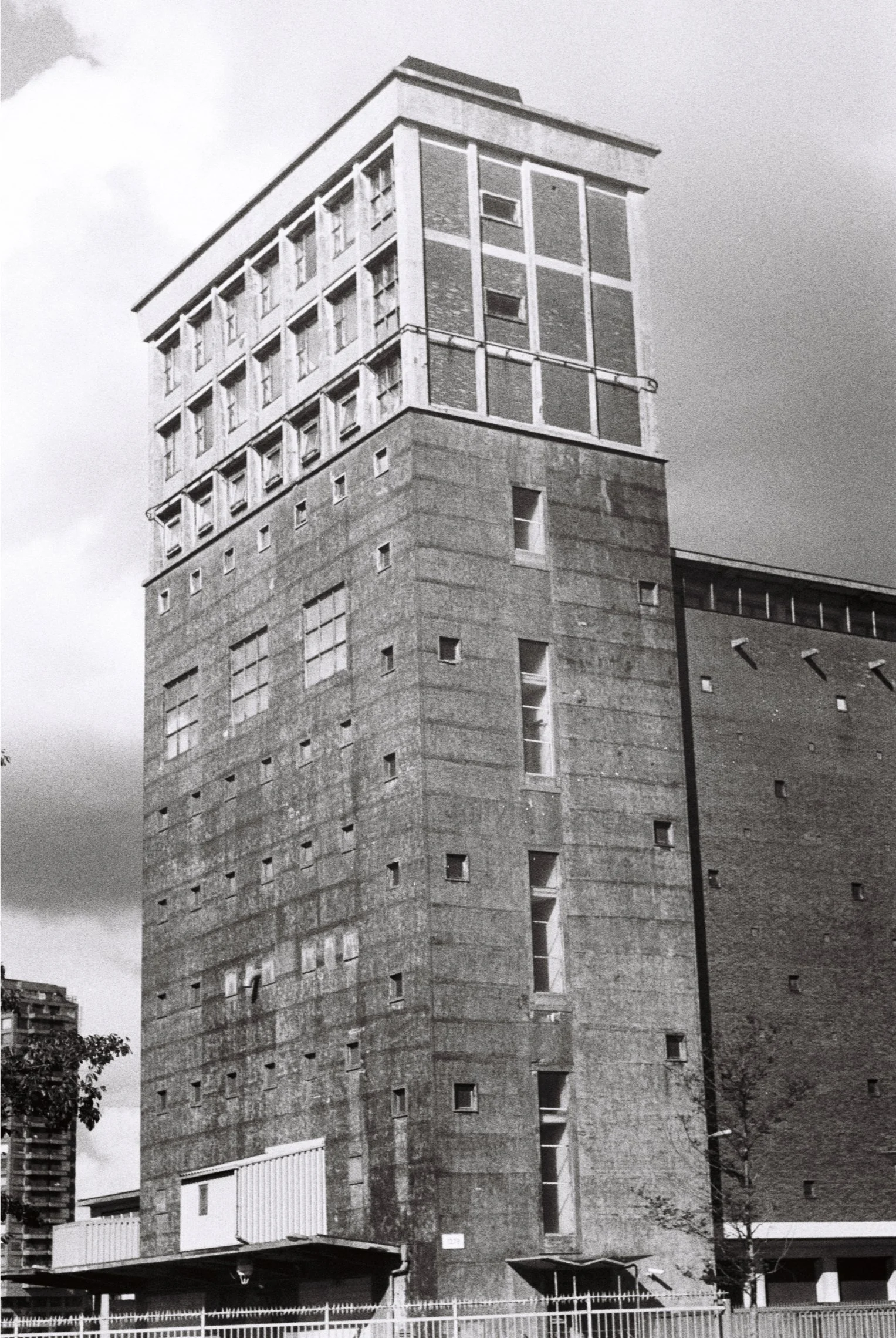 Black and white photo of a tall modernist industrial building