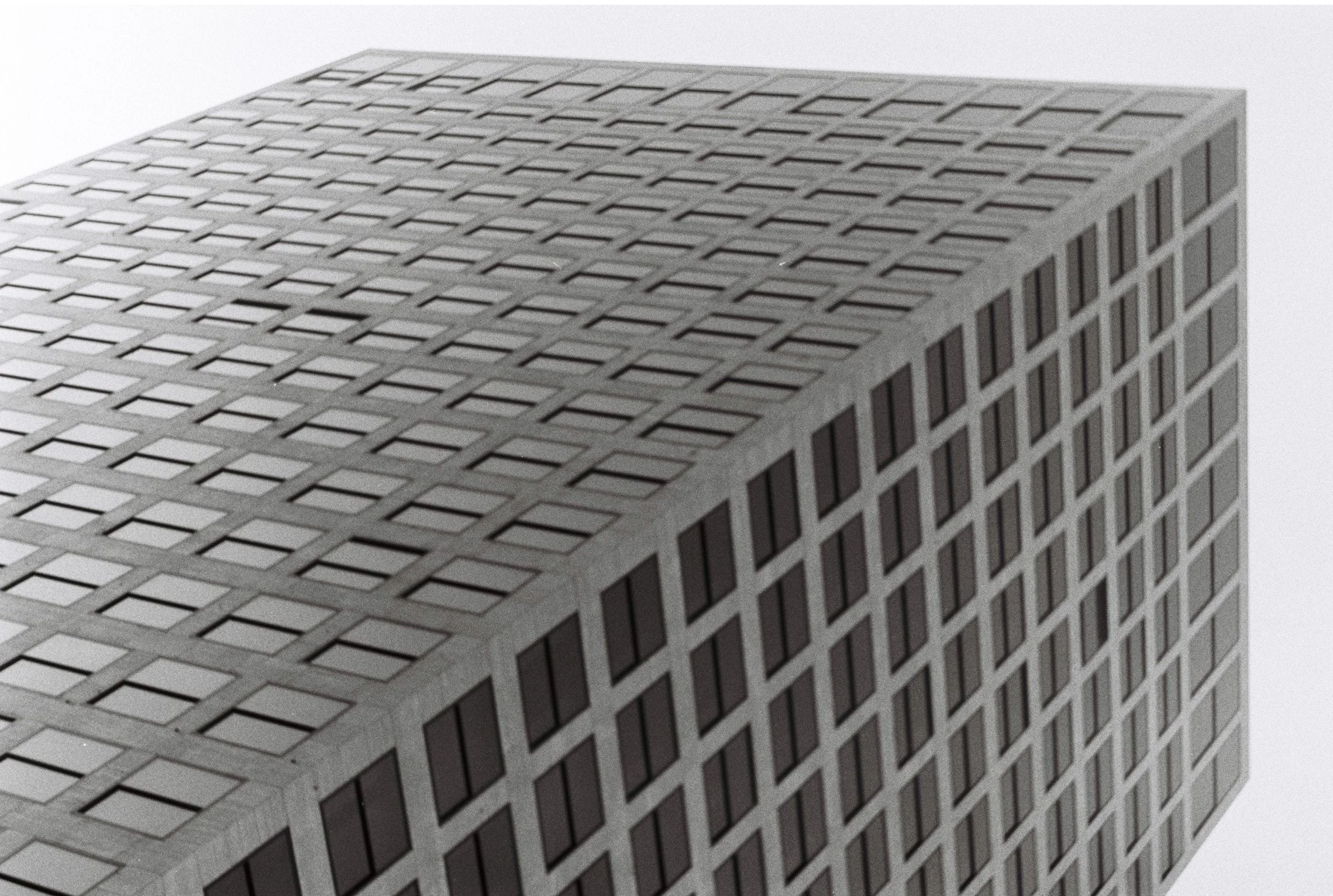 Close-up of a tall modern office building with a grid of windows reflecting the sky