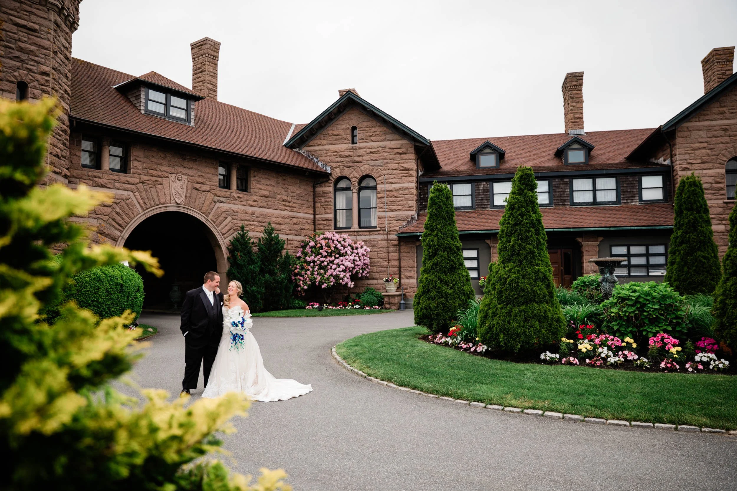 A bride and groom on the drive at OceanCliff in Newport