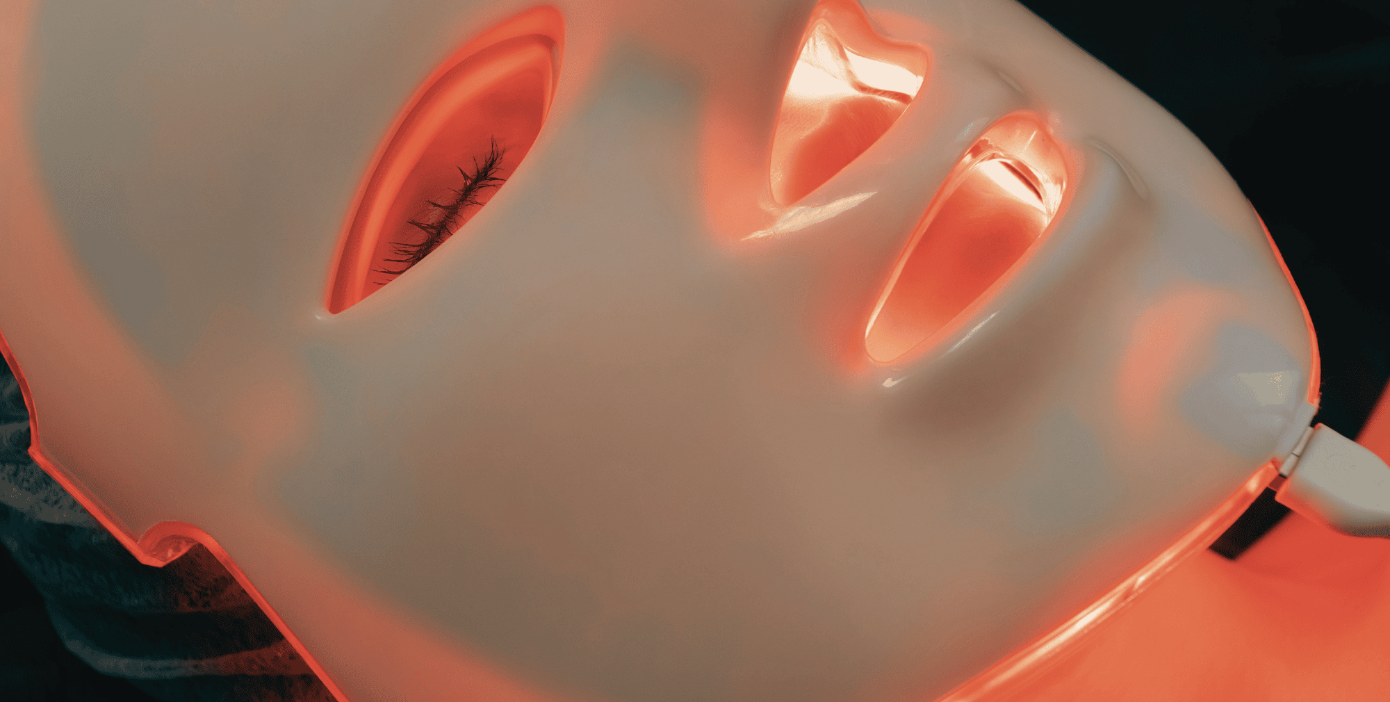 Red light therapy mask paired with a sound frequency routine for enhanced collagen support and skin recovery