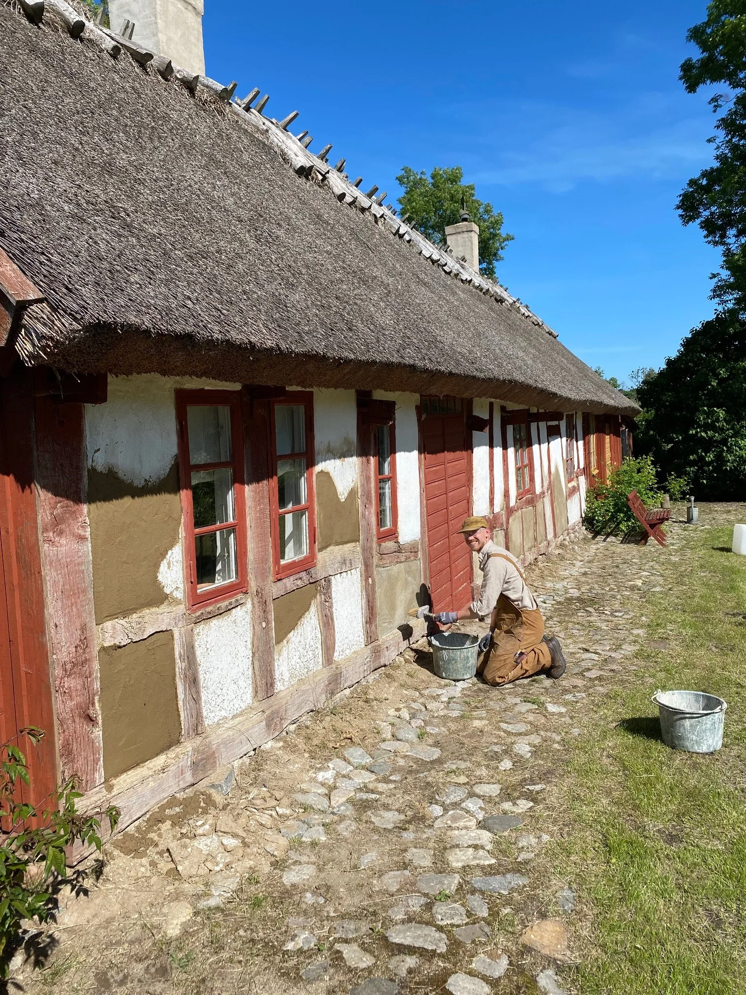Oskar Wiklund från Hantverksnörden utför traditionell byggnadsvård och putsning på ett korsvirkeshus med vasstak. Expert på hållbart bygghantverk och renovering av äldre hus.
