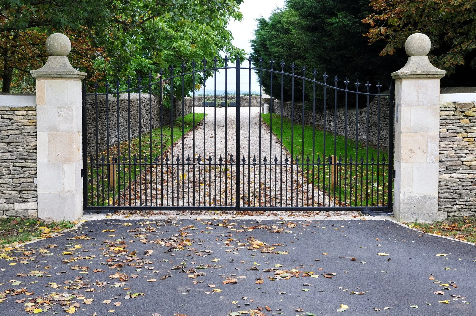 rusted metal driveway gate sagging on its hinges