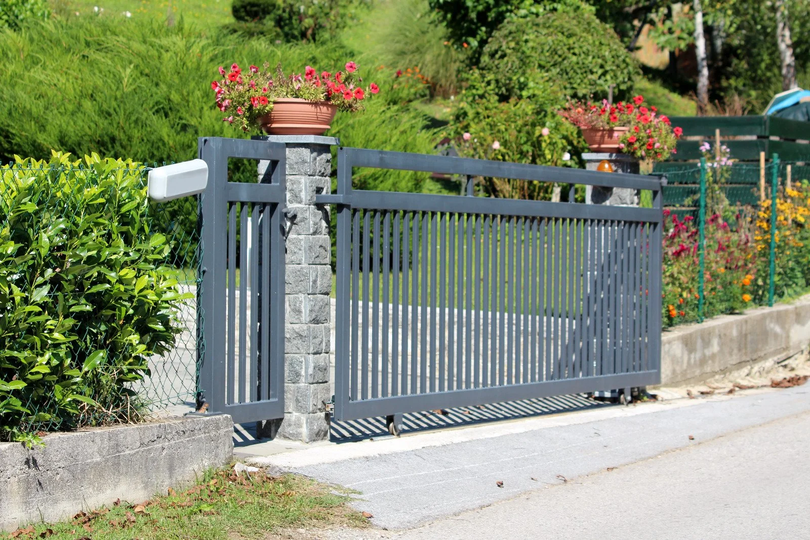 residential swinging driveway gate hinge close-up
