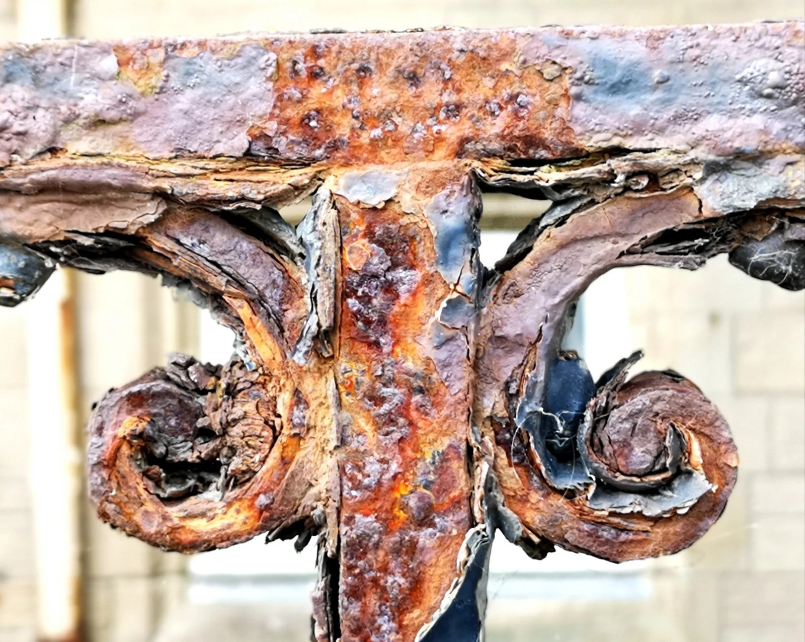 wrought iron gate with chipped black paint exposing rust