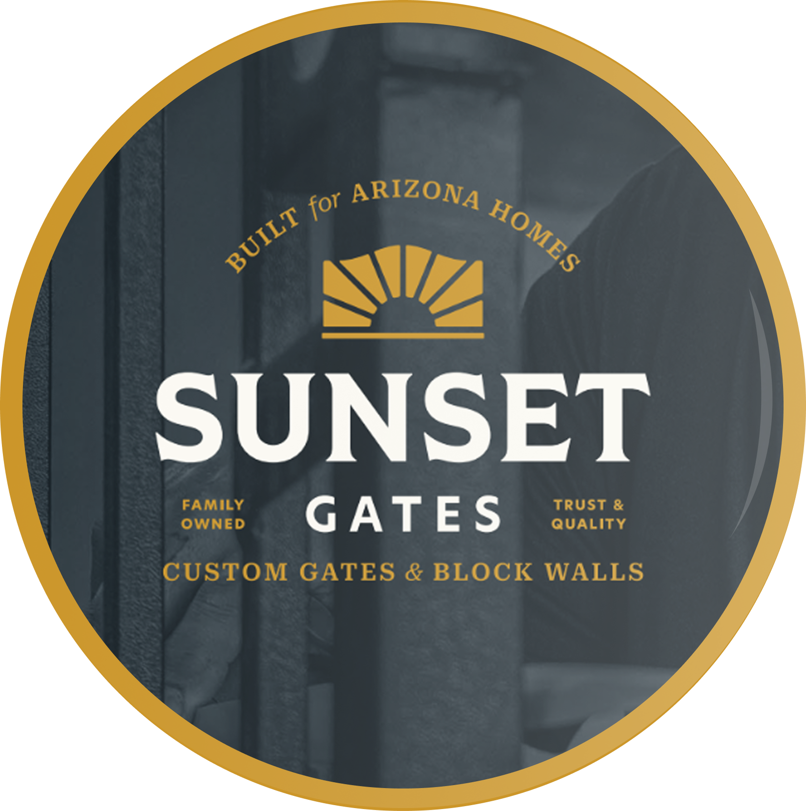Close-up of a black metal gate with a sign that reads 'Built for Arizona Homes' and 'Sunset Gates' with additional text about custom gates and block walls.