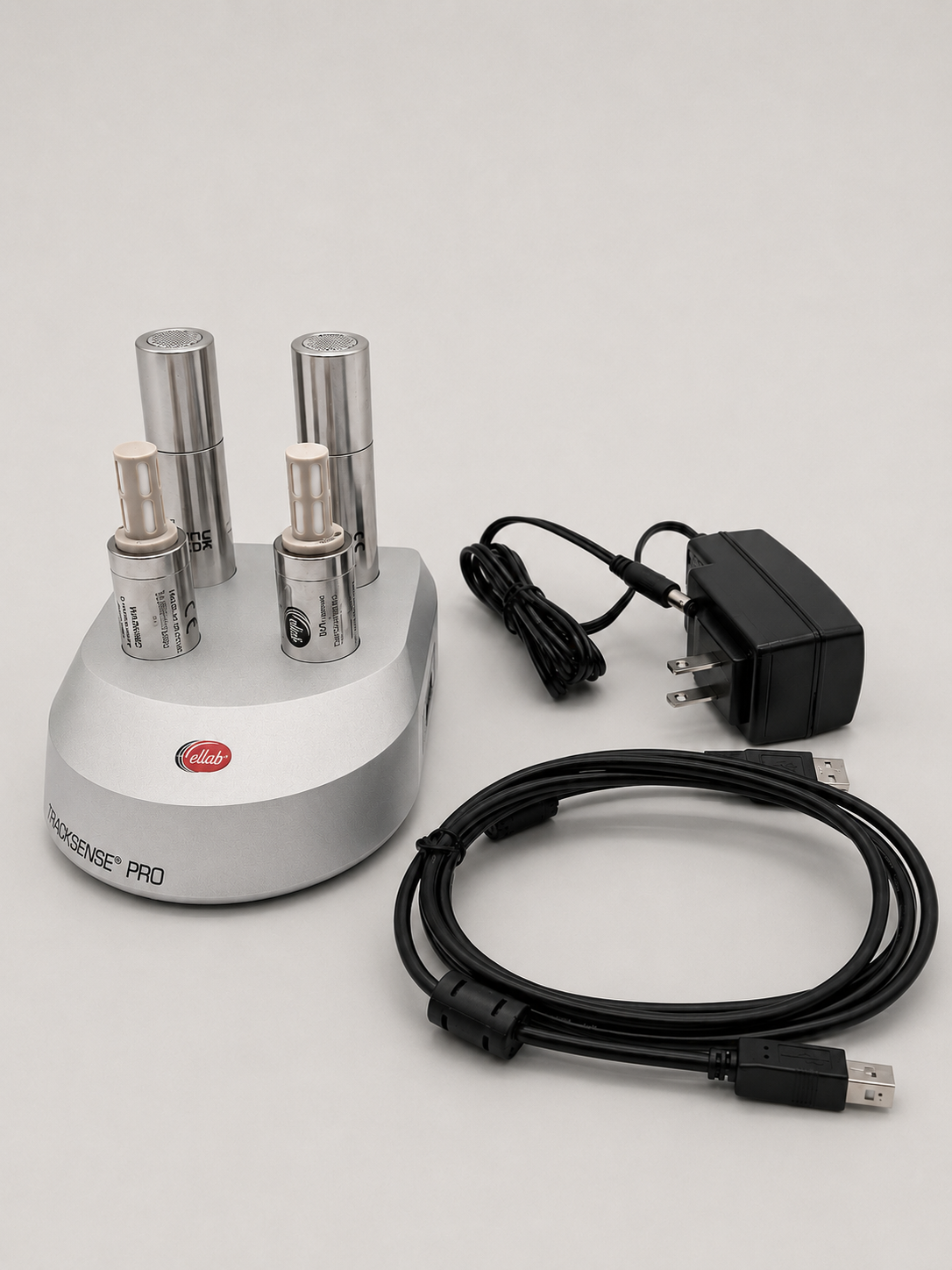 TrackSense Pro validation equipment with stainless steel sensors, USB cable, and power adapter.