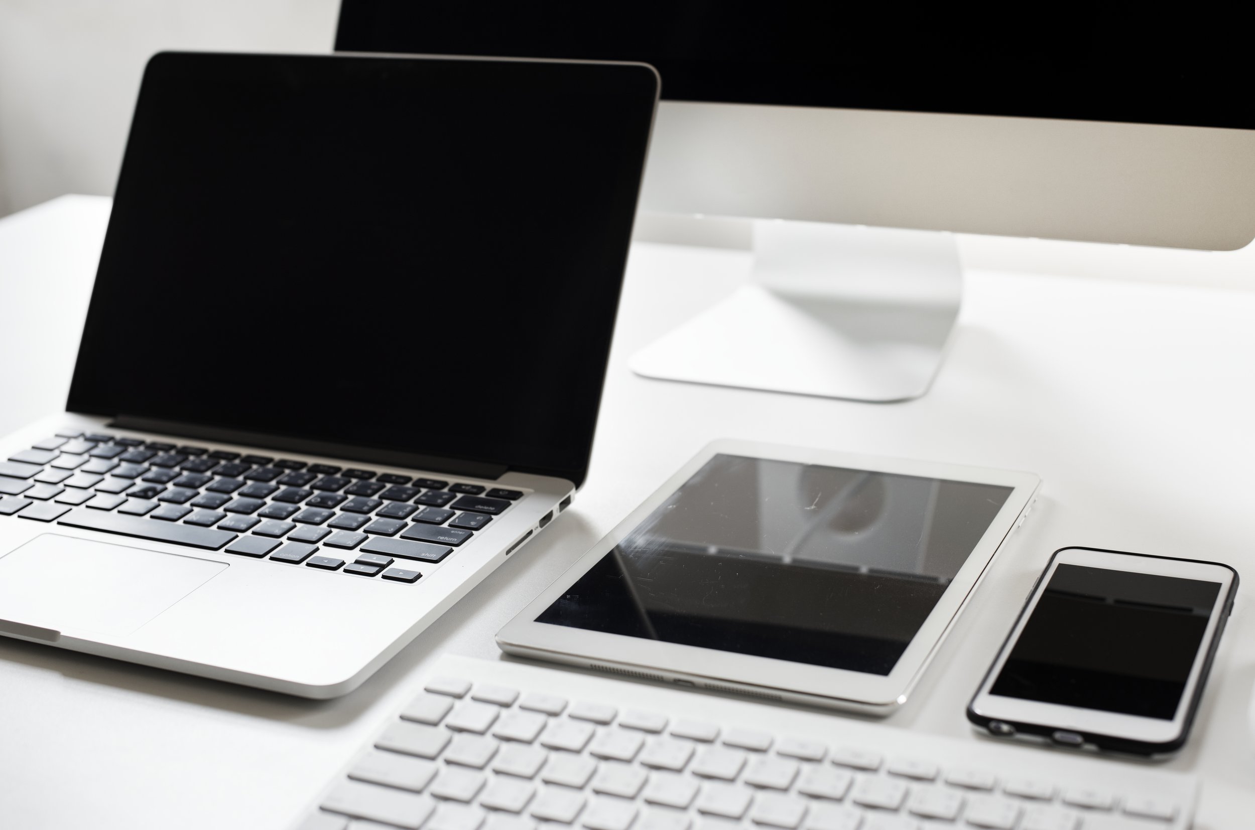 Un téléphone portable rose et une tablette flottant au-dessus d'un socle blanc, le tout sur un fond gris clair.