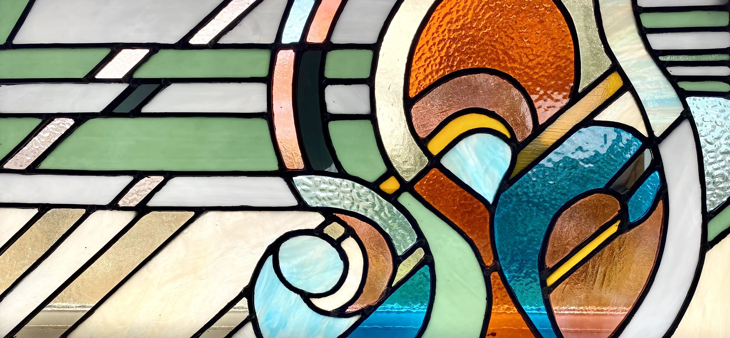Zoe Henderson stained glass artist interior  fairground inspired fanlight Best stained glass in London