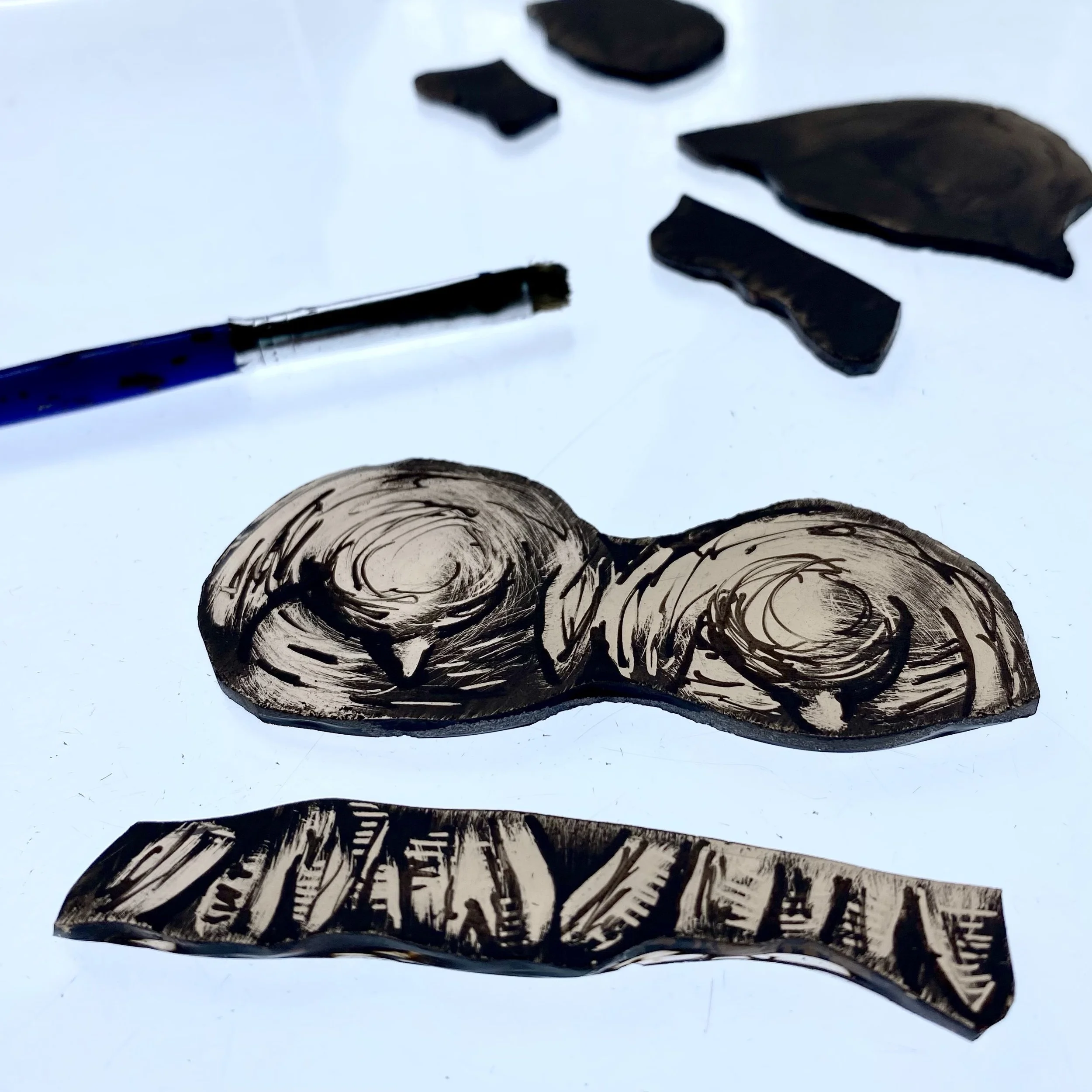 Black ink drawing of layered shell-like shapes on white paper.