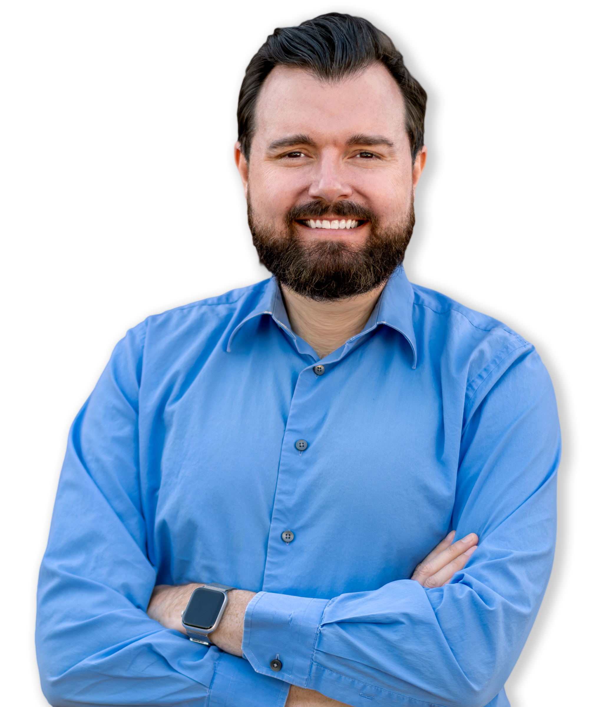 A smiling man with a beard and dark hair, wearing a blue button-up shirt and a smartwatch, standing with arms crossed against a black background.