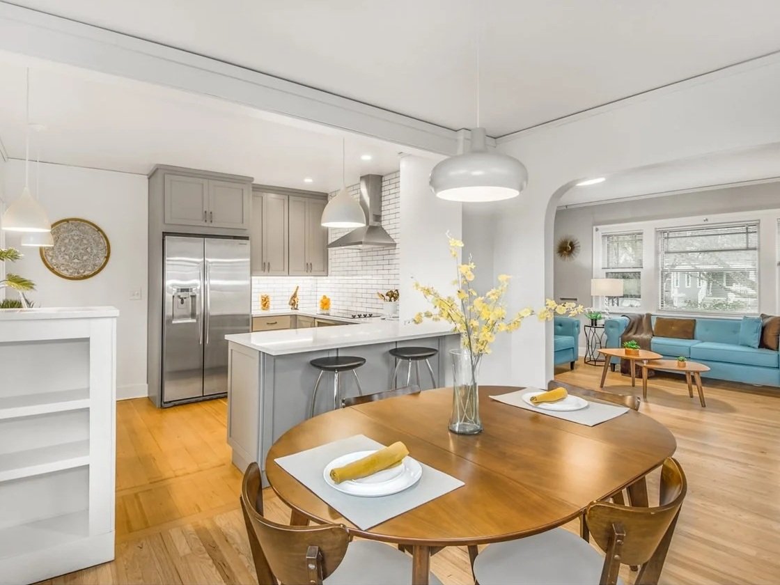 A renovated dining room next to a updated modern kitchen in a 1920's cottage renovation in Portland, Oregon.