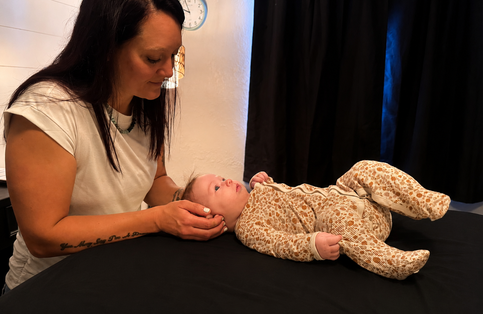 Nicole Amisone providing gentle craniosacral and fascial therapy for a baby to support relaxation, breastfeeding difficulties, nervous system function, and tongue tie/tethered oral tissues.