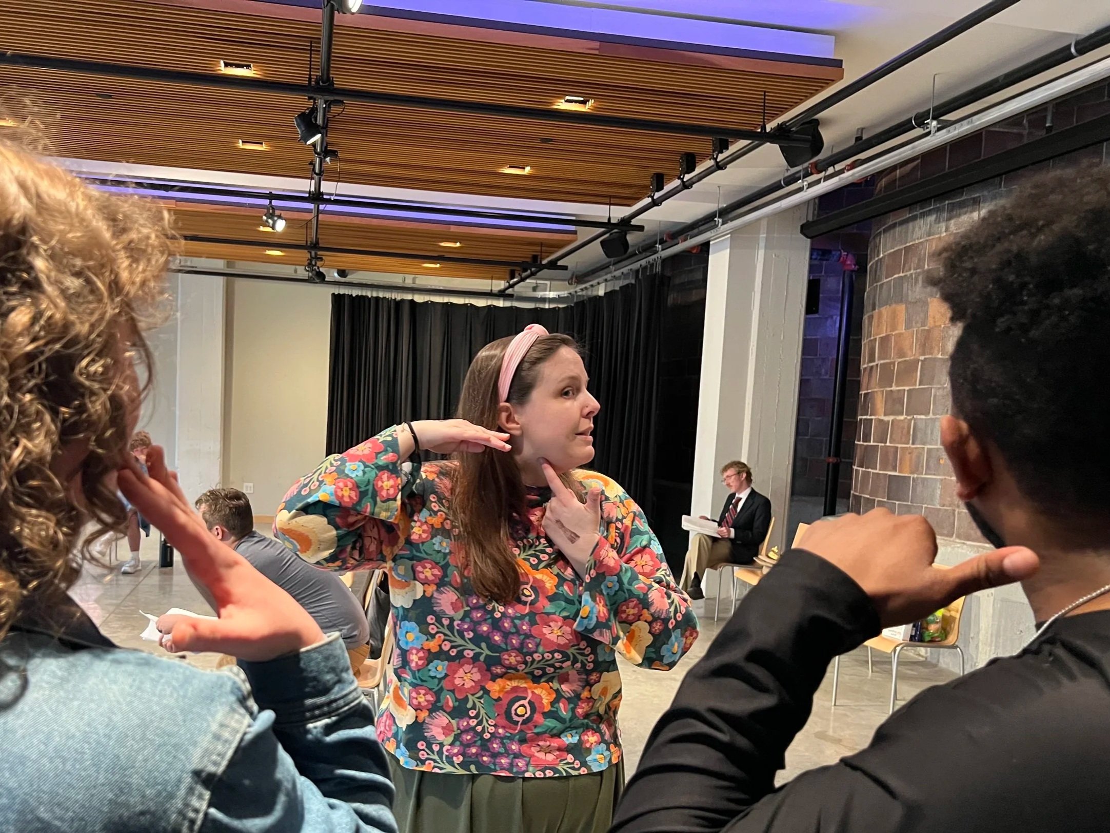 Gillian demonstrating oral posture to two actors.