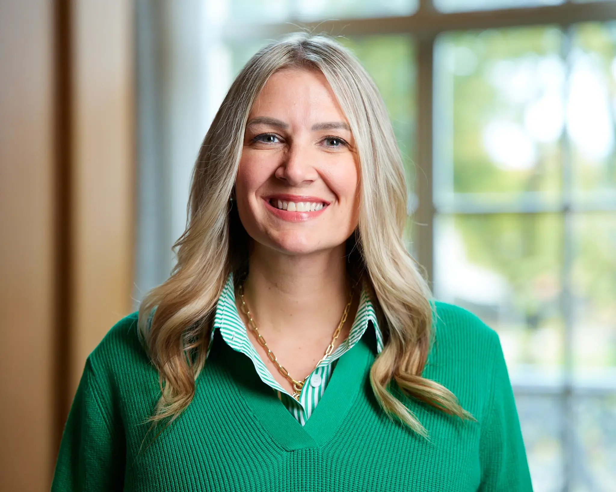 executive assistant smiling for a headshot session during company event