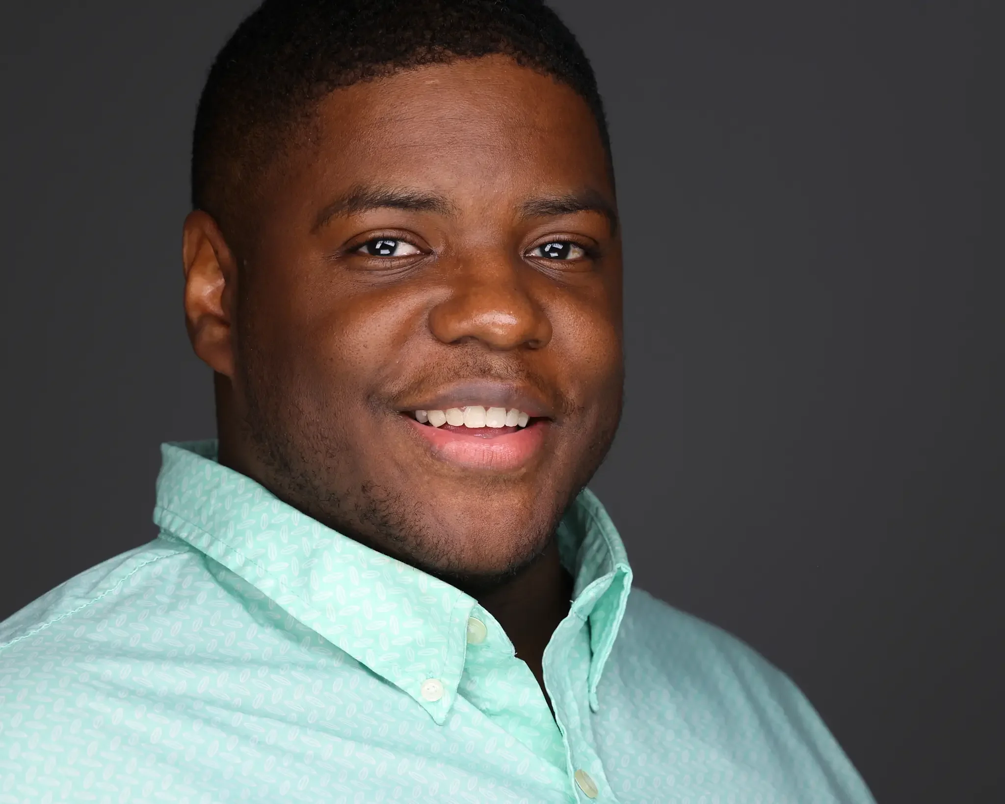 executive smiling for a headshot during their company outing