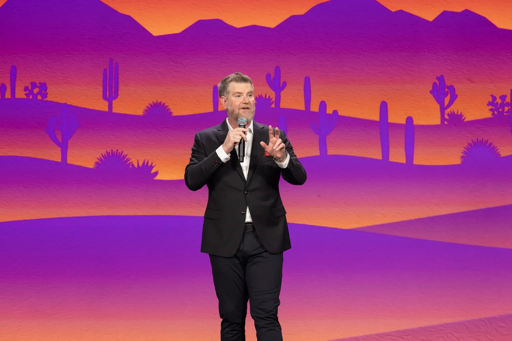 keynote speaker addressing the crowd on stage