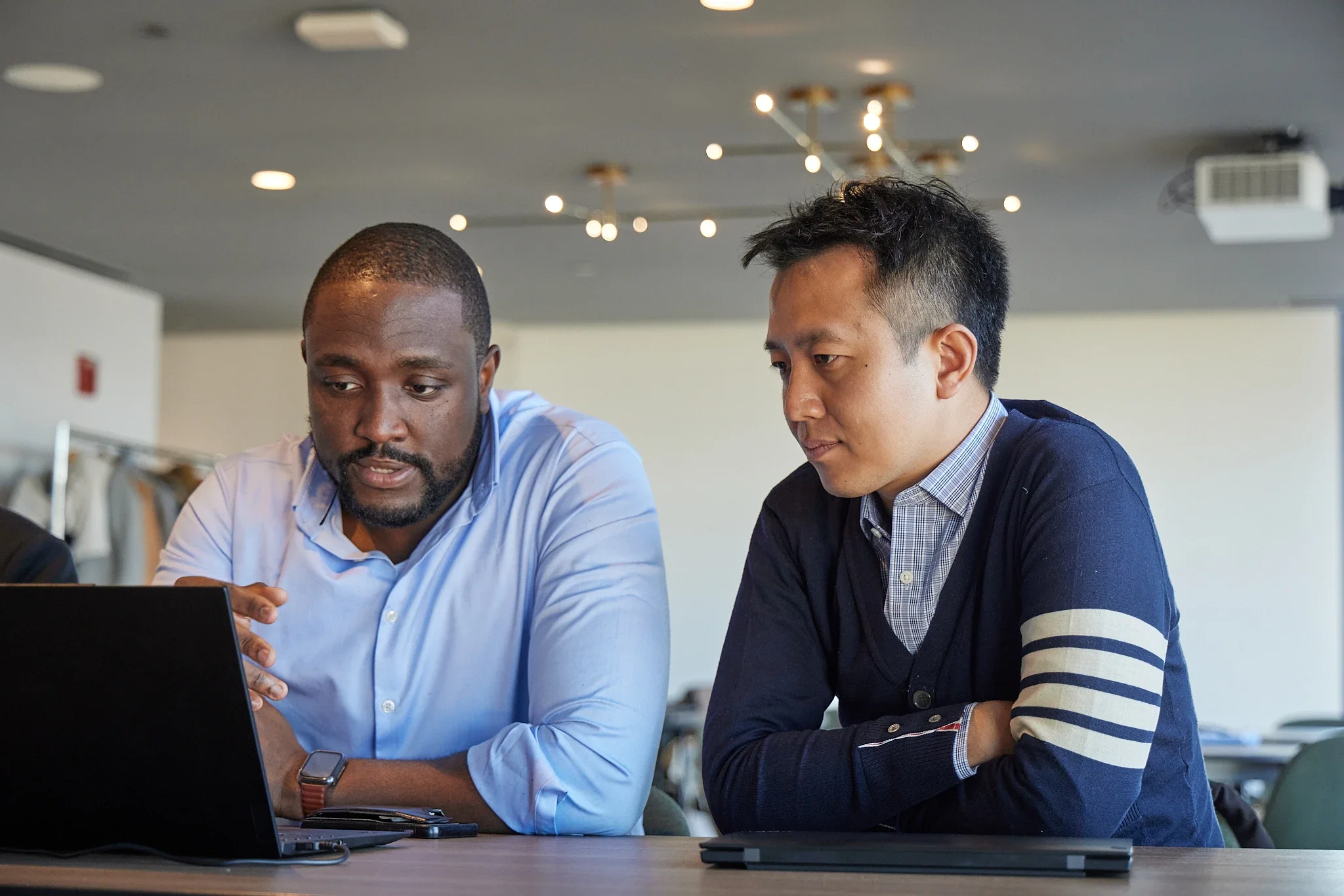 two employees reviewing information on a computer together
