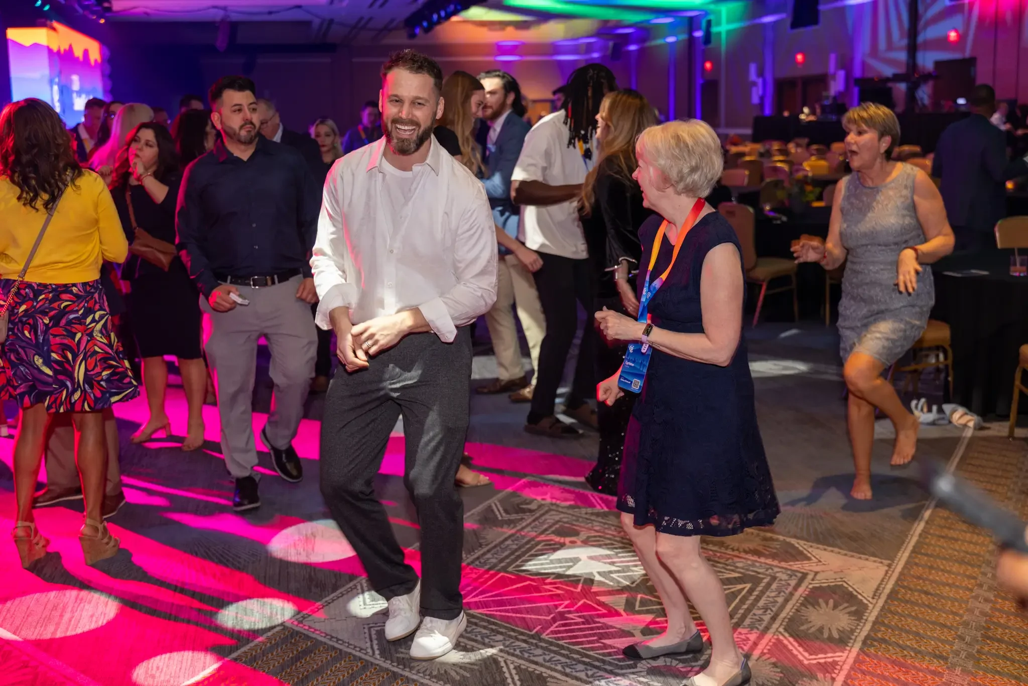 people dancing to celebrate after a corporate kick off event