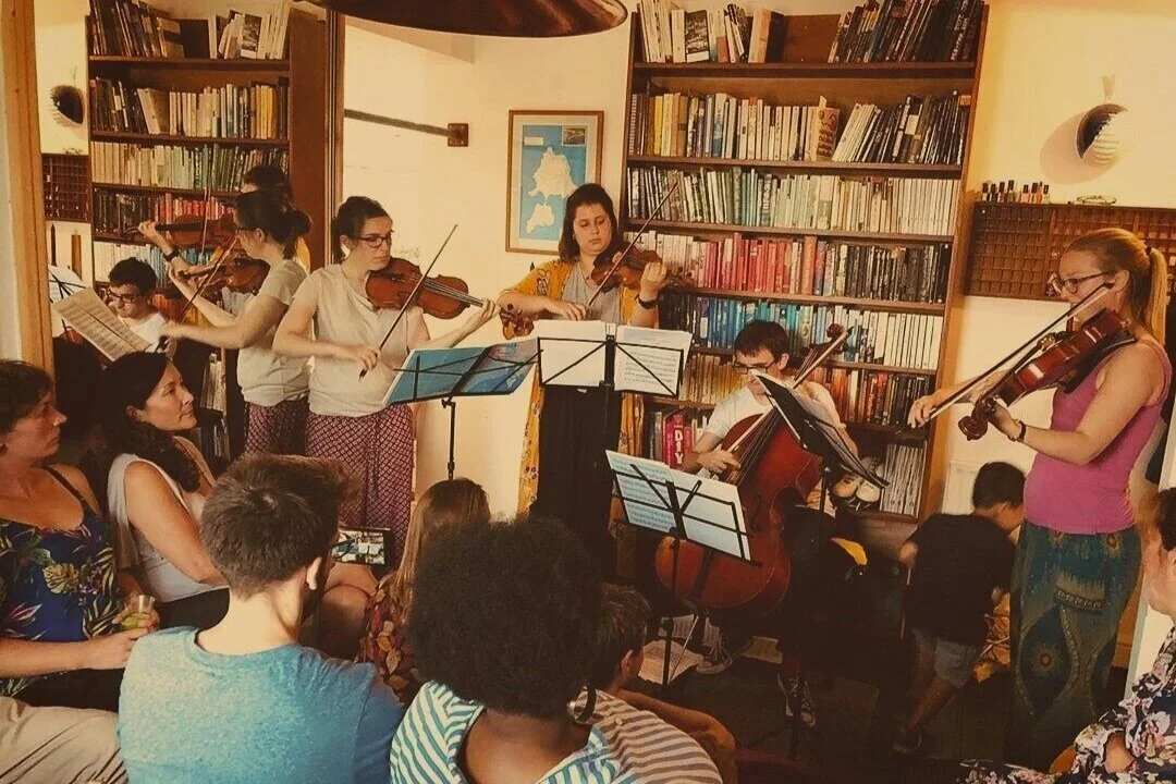 Florian Ensemble house concert, string quartet performing standing up in a living room