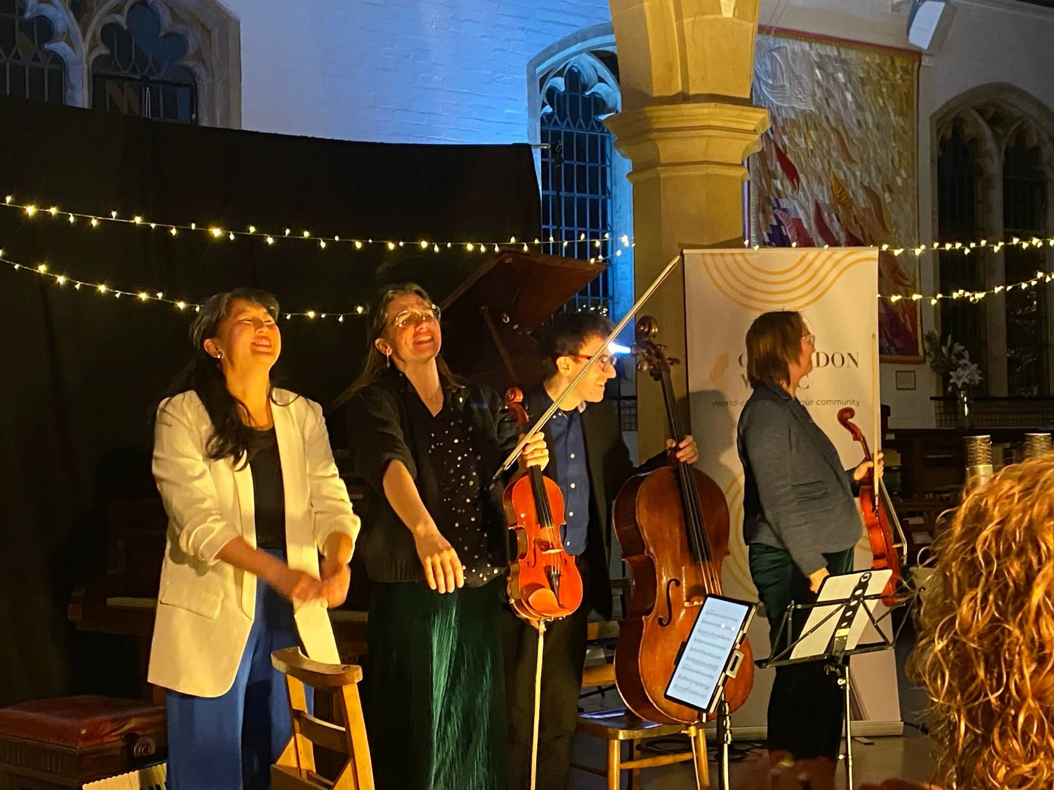 Florian Ensemble musicians standing taking applause inside a church after Coulsdon Music inaugural Christmas Concert 2025