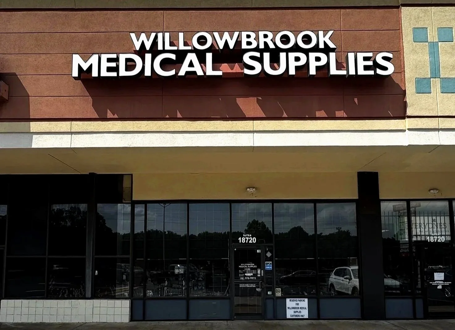 Exterior view of Willowbrook Medical Supplies store with a large sign on the building and glass windows.