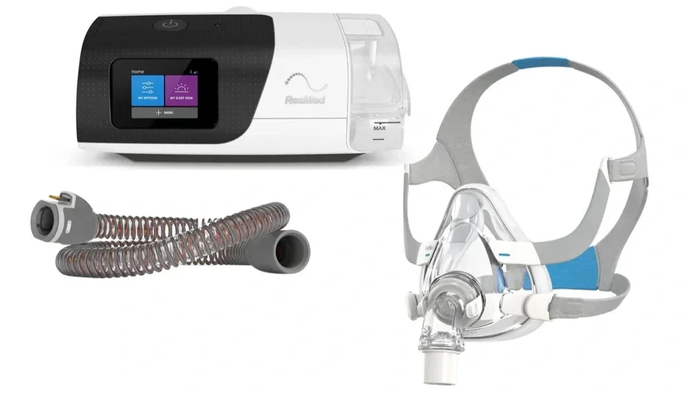 A CPAP machine, a breathing tube, and a sleep mask with headgear used for sleep apnea treatment.