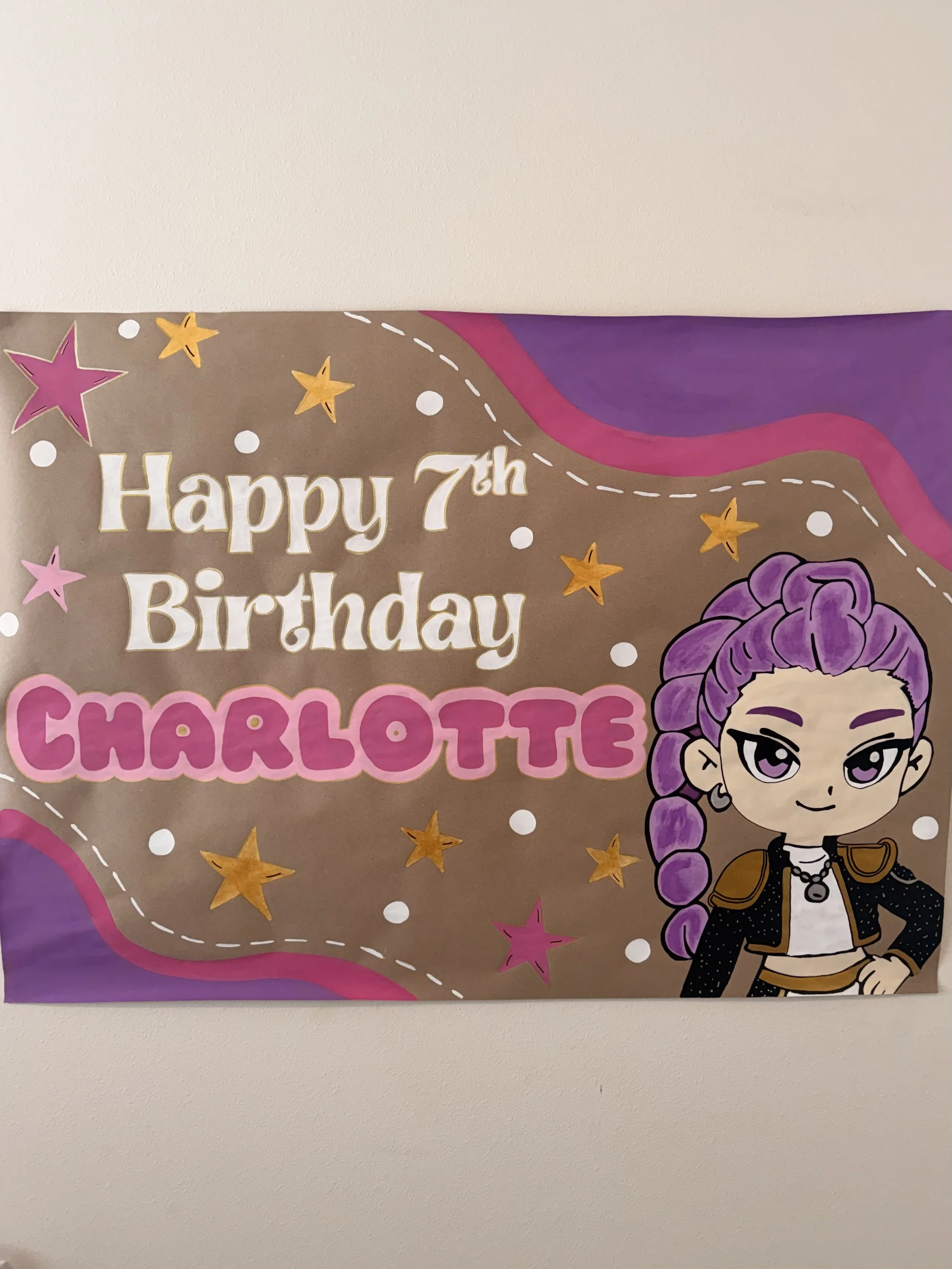 Colorful birthday banner with a cartoon character, purple hair, and stars, celebrating Charlotte's 7th birthday.