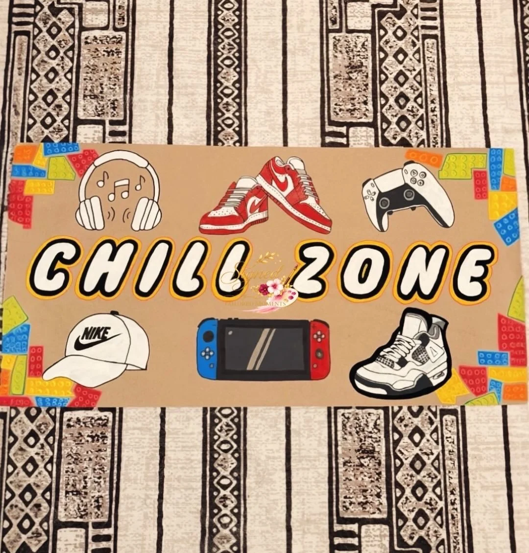 Colorful sign reading 'Chill Zone' with icons of headphones, sneakers, game controller, cap, handheld gaming device, and LEGO pieces on a beige background.