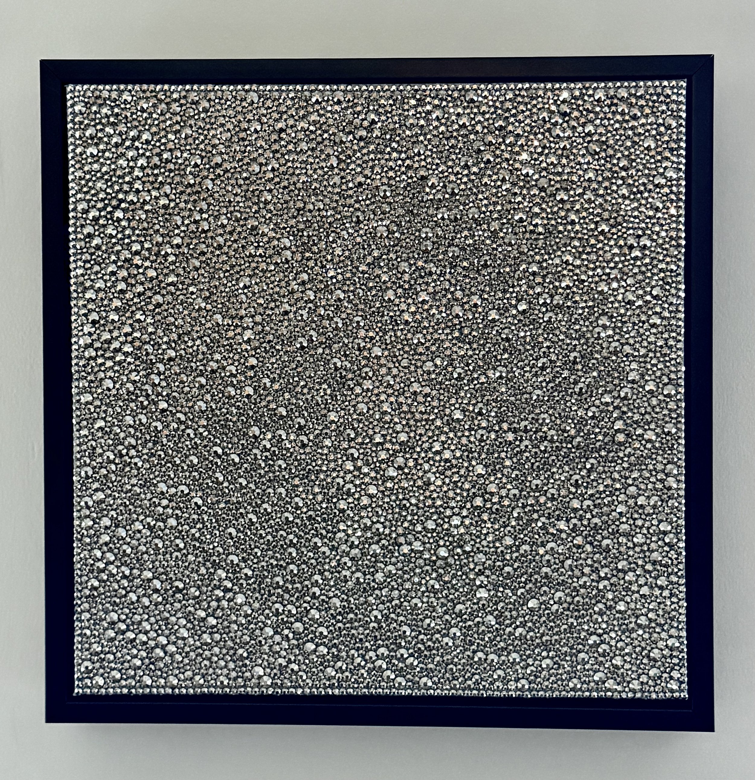 Sloth (2026). 12x12 in. sculptural panel in a black frame. Features hand-placed hematite glass rhinestones in a monochromatic field.