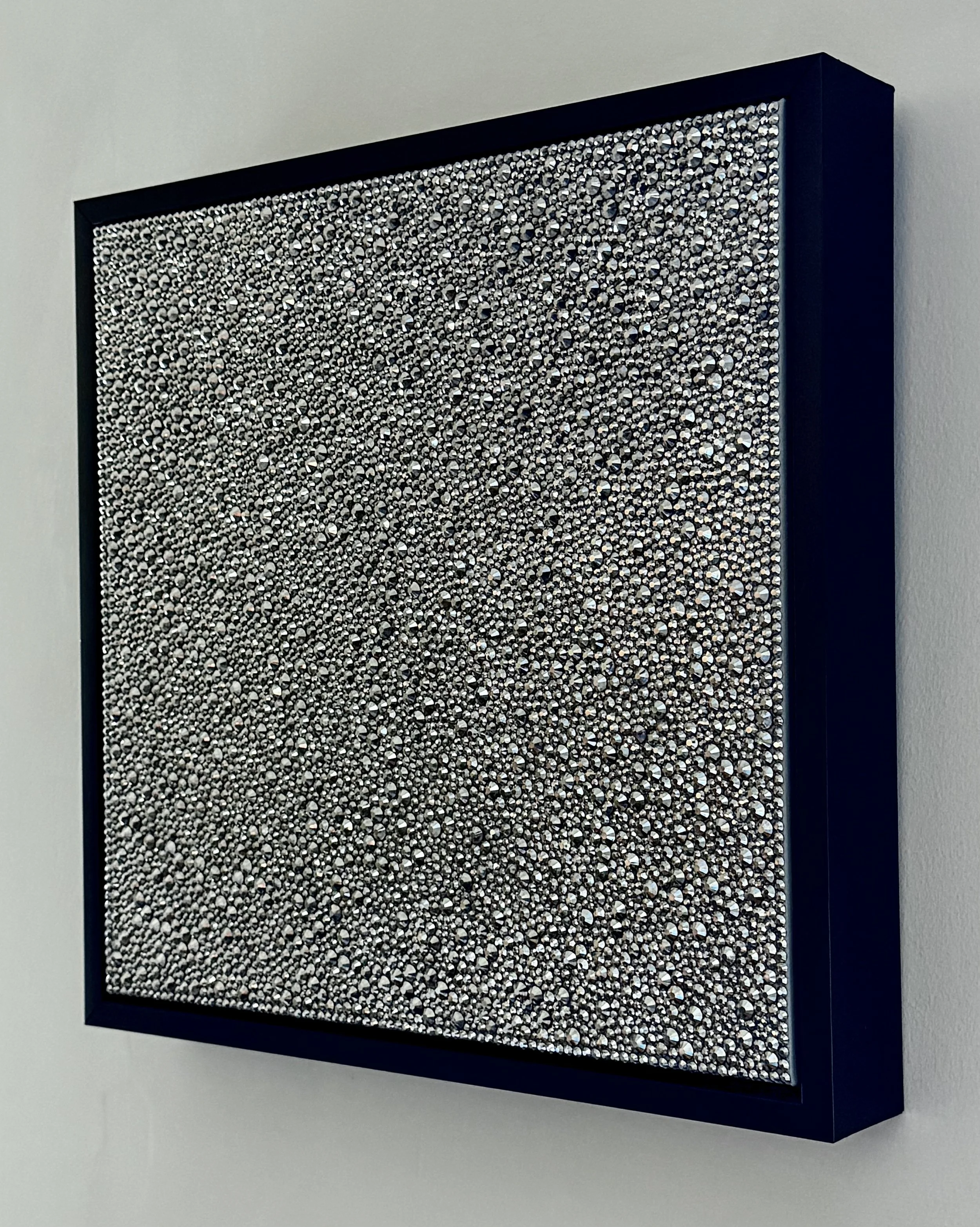 Side view of Sloth (2026) showing the 3D texture of hematite rhinestones and the black floating frame. Highlights the depth and sculptural profile.
