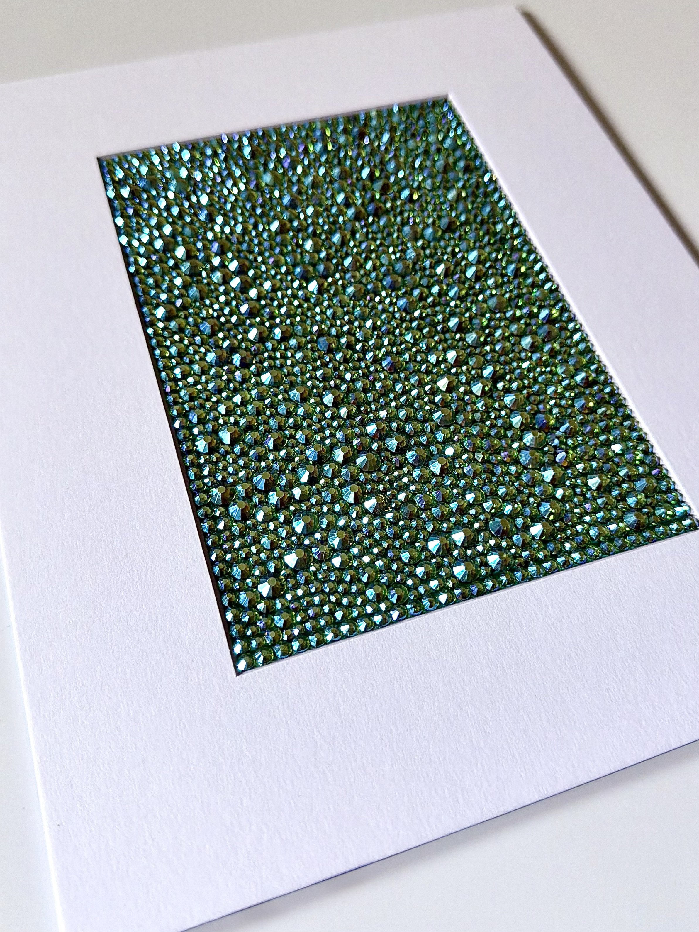 An angled close-up of the "Vacant" paper study, showing the high-relief texture of the green and gold rhinestone field.