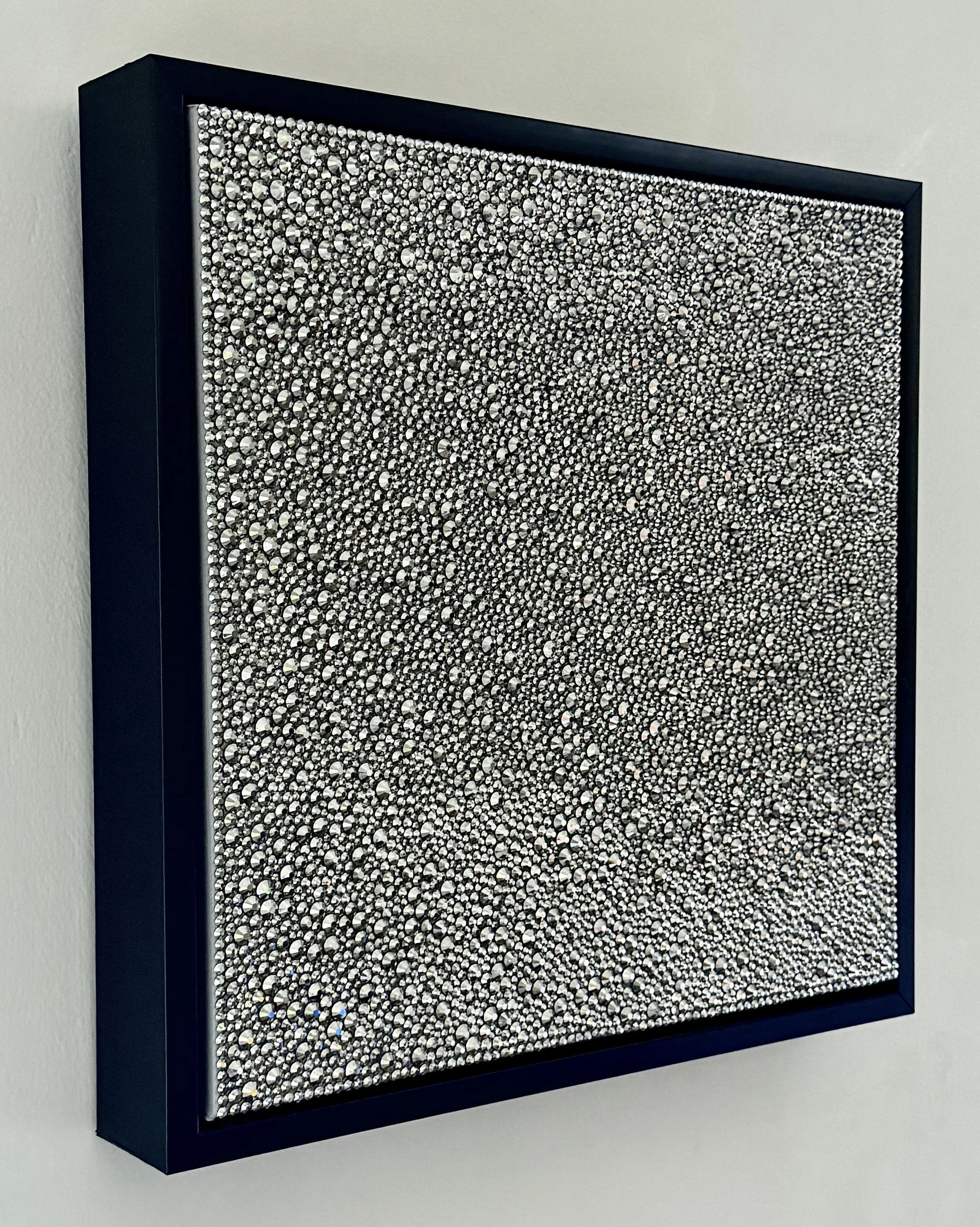 Side view of Sloth (2026) showing the 3D texture of hematite rhinestones and the black floating frame. Highlights the depth and sculptural profile.