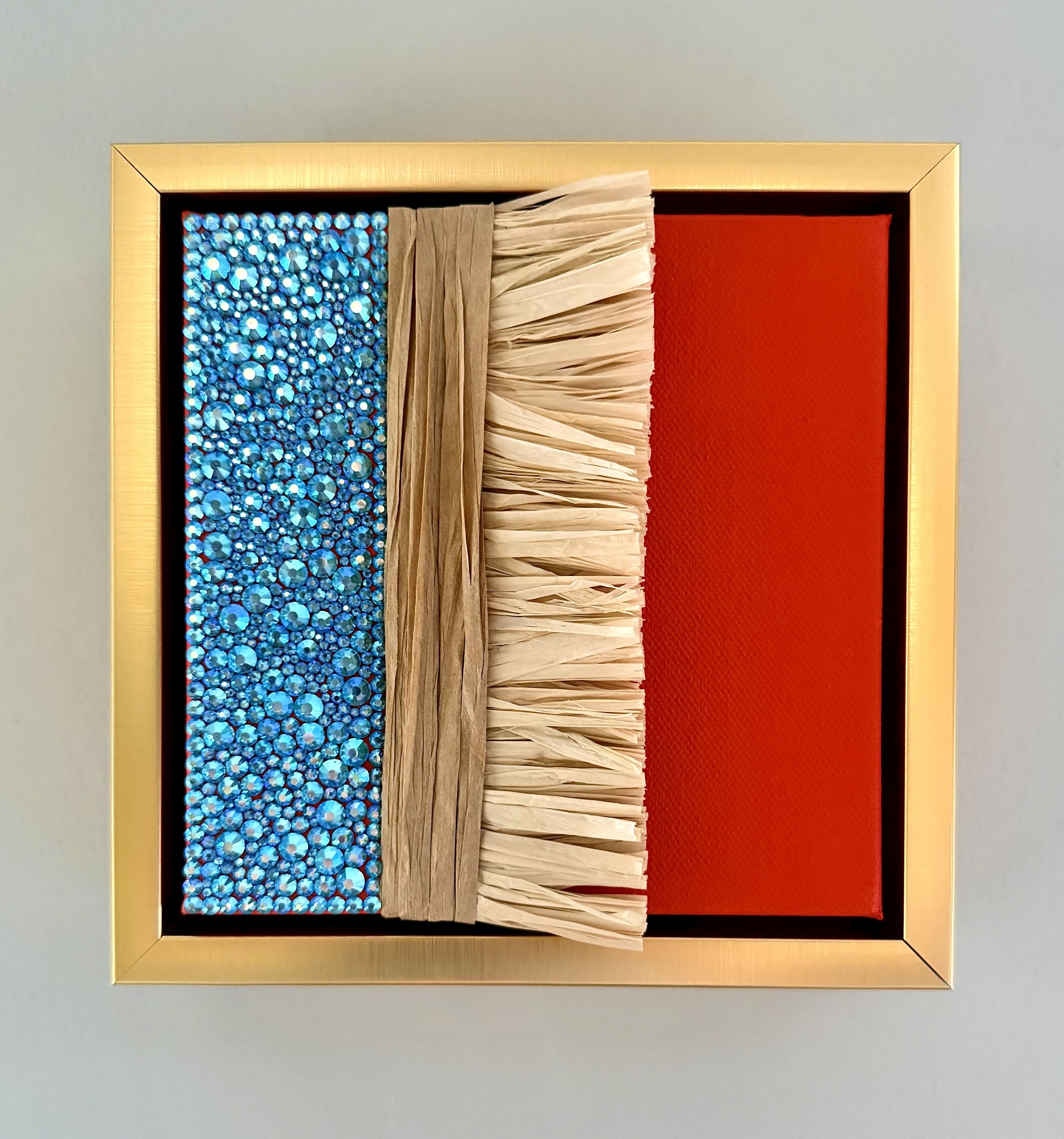 "Entropy" a 6x6 inch mixed-media piece of aqua AB rhinestones and natural raffia in a brushed-gold floating frame.