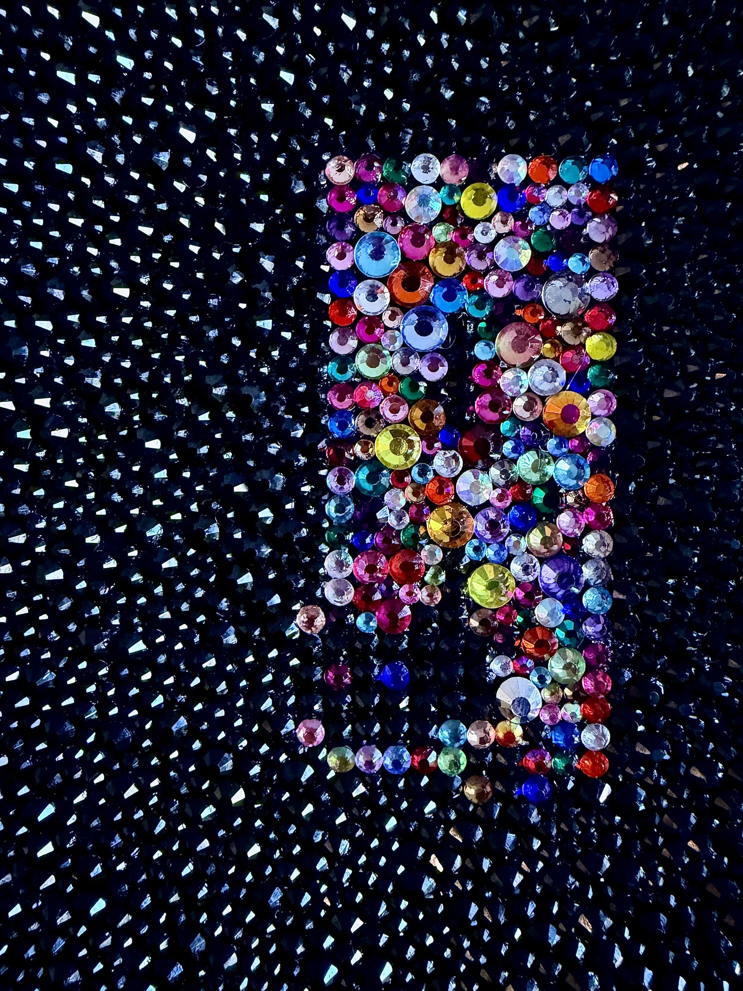 Macro close-up of "Unease," detailing the black rhinestone field and the complex, clustered texture of varied multi-colored rhinestones.